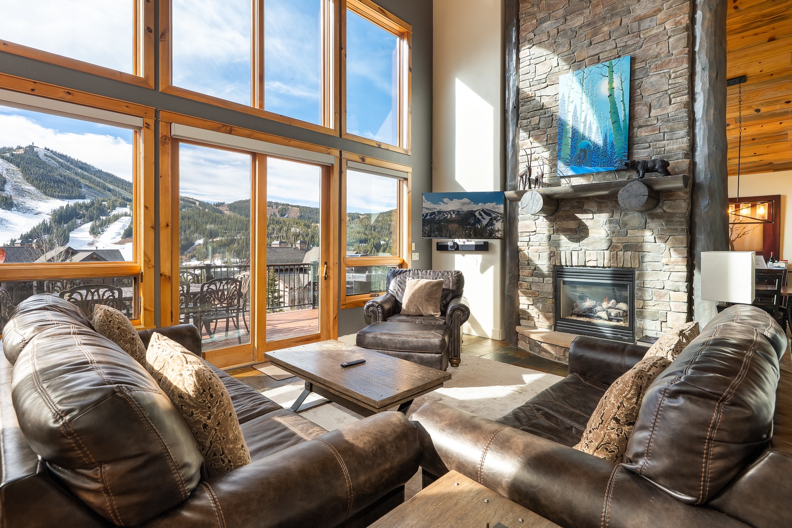 Sink into plush leather seating by your crackling fireplace while soaking up breathtaking mountain views through floor-to-ceiling windows.