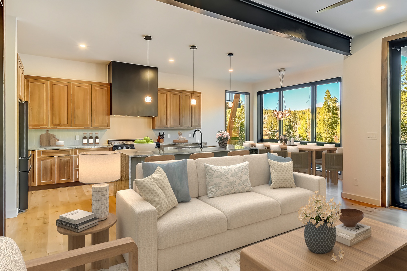 Relax in this stunning open-concept space where your living room flows seamlessly into the gourmet kitchen, all framed by forest views.