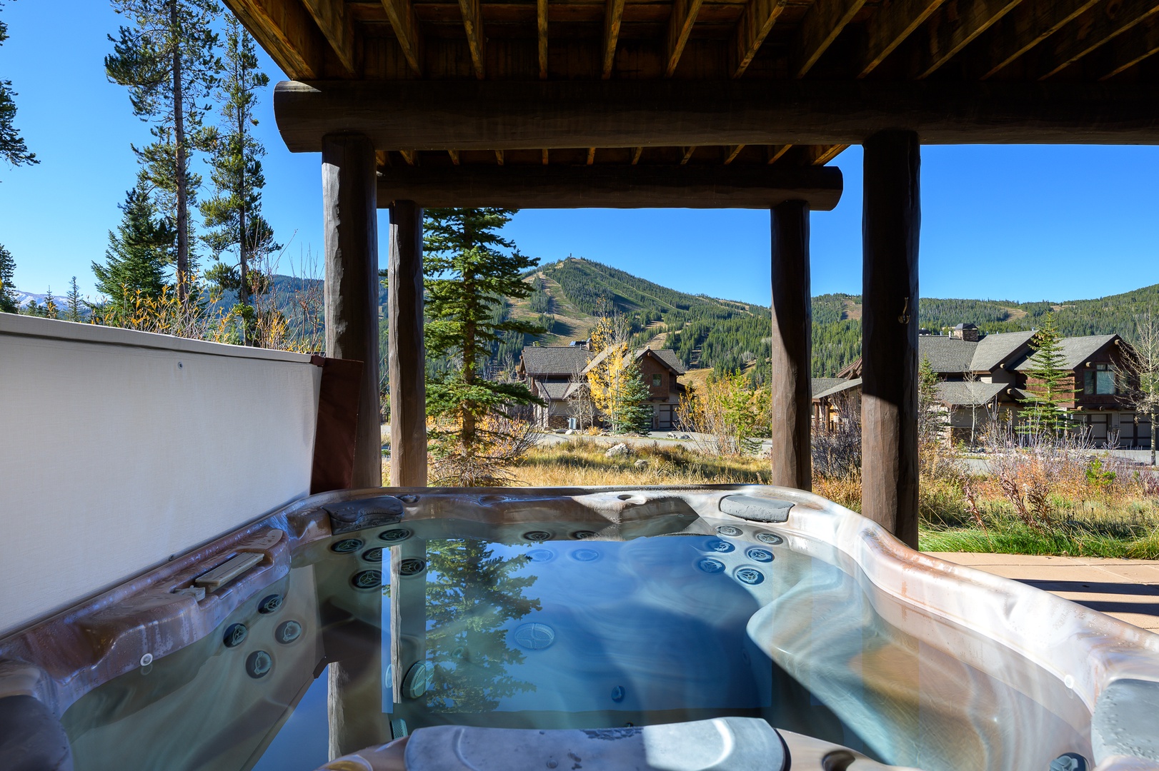 Soak in the bubbling hot tub while gazing at stunning mountain views from your private covered deck.