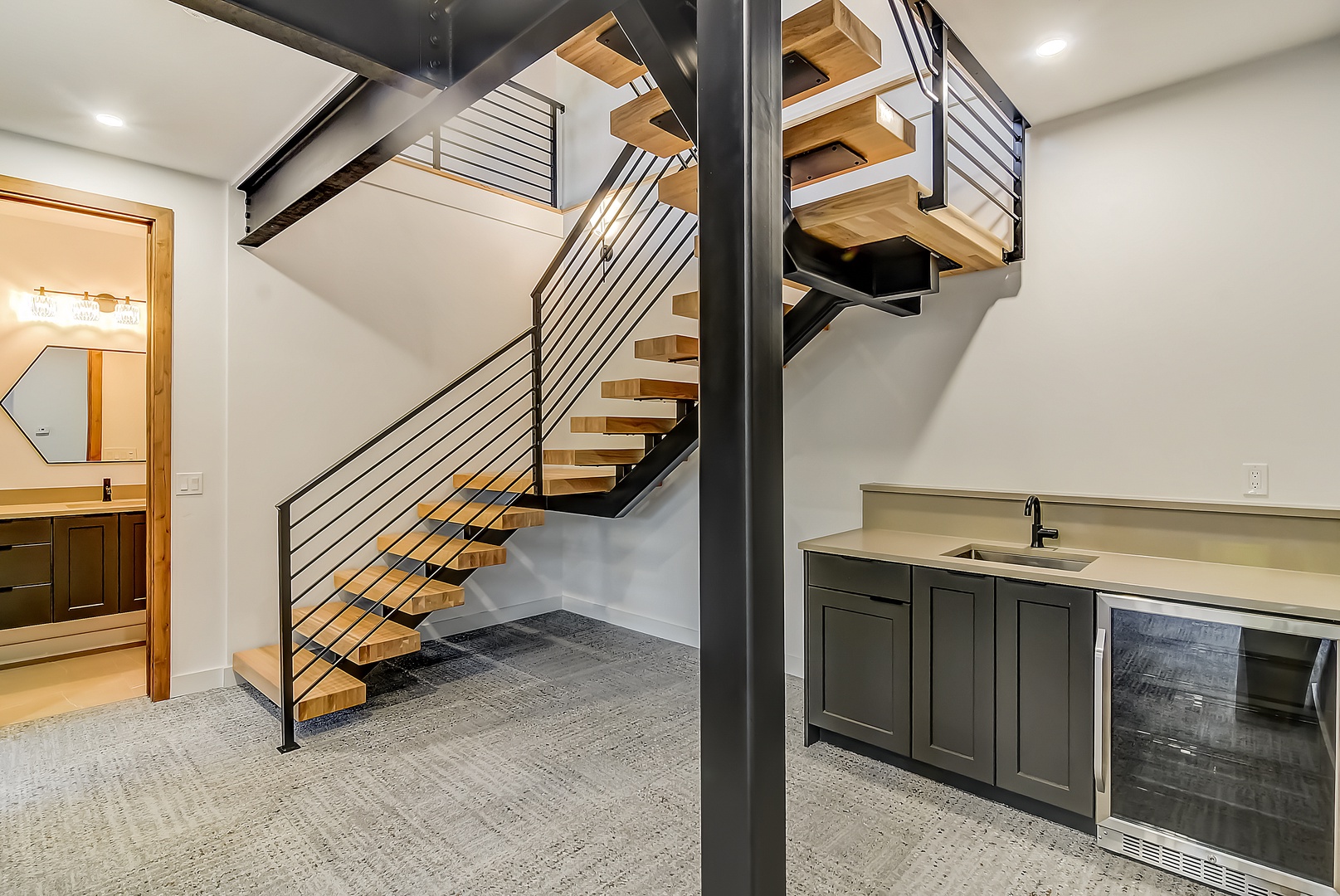 Your modern retreat features a stunning floating staircase and sleek wet bar, perfect for entertaining guests in style.