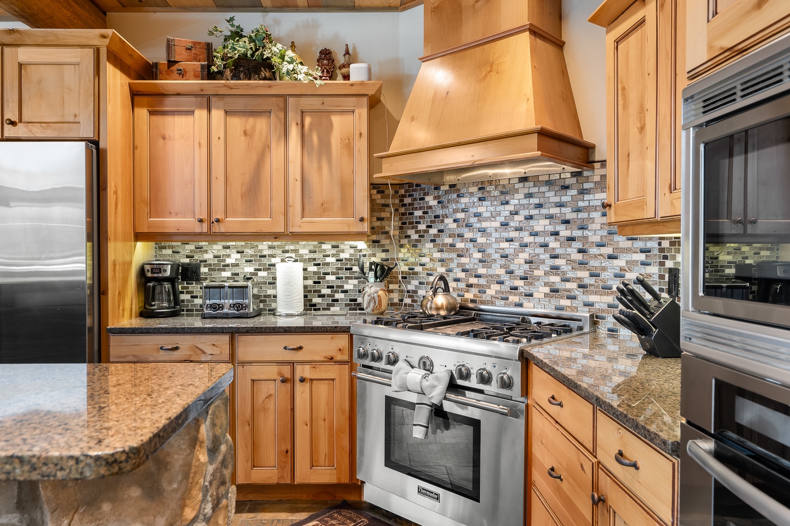 Your gourmet kitchen awaits with warm wood cabinets, granite counters, and professional-grade appliances ready for culinary adventures.