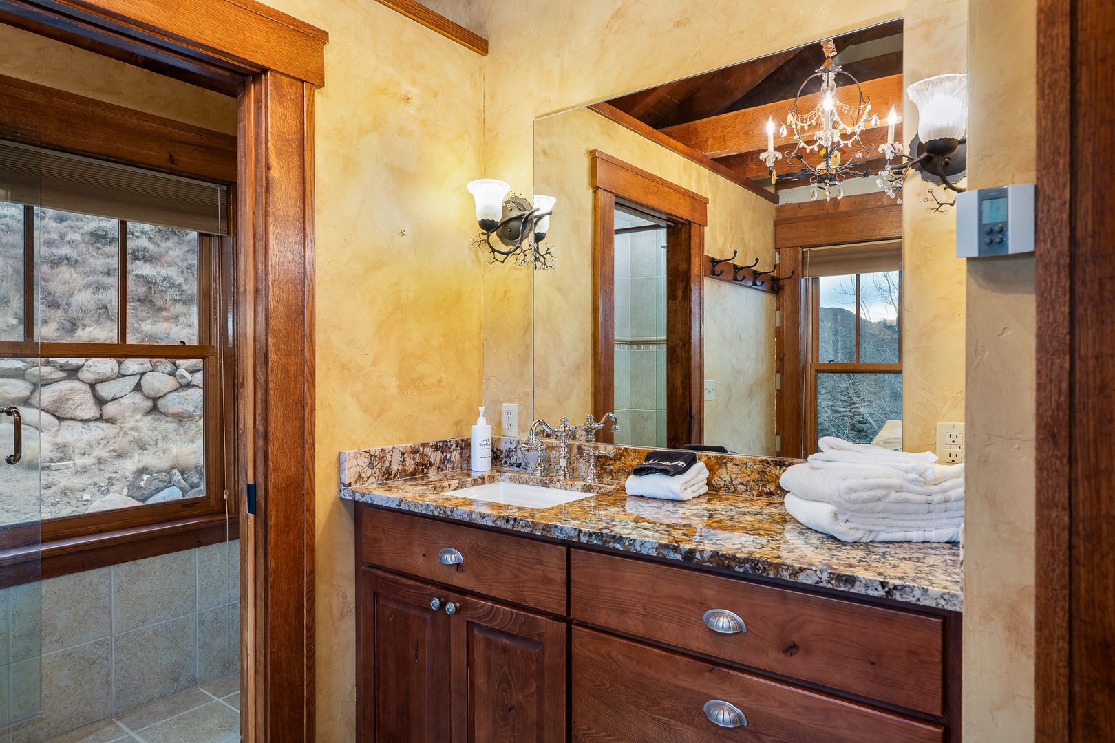 Unwind in your luxurious bathroom featuring elegant lighting