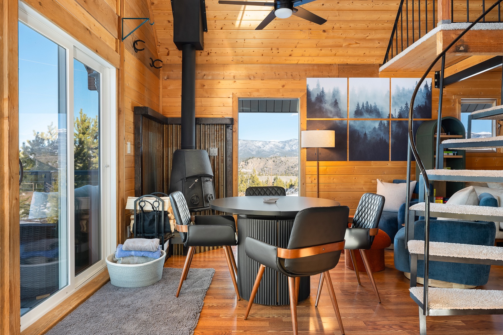 Relax in your stylish mountain retreat with soaring wood ceilings and breathtaking alpine views through floor-to-ceiling windows.