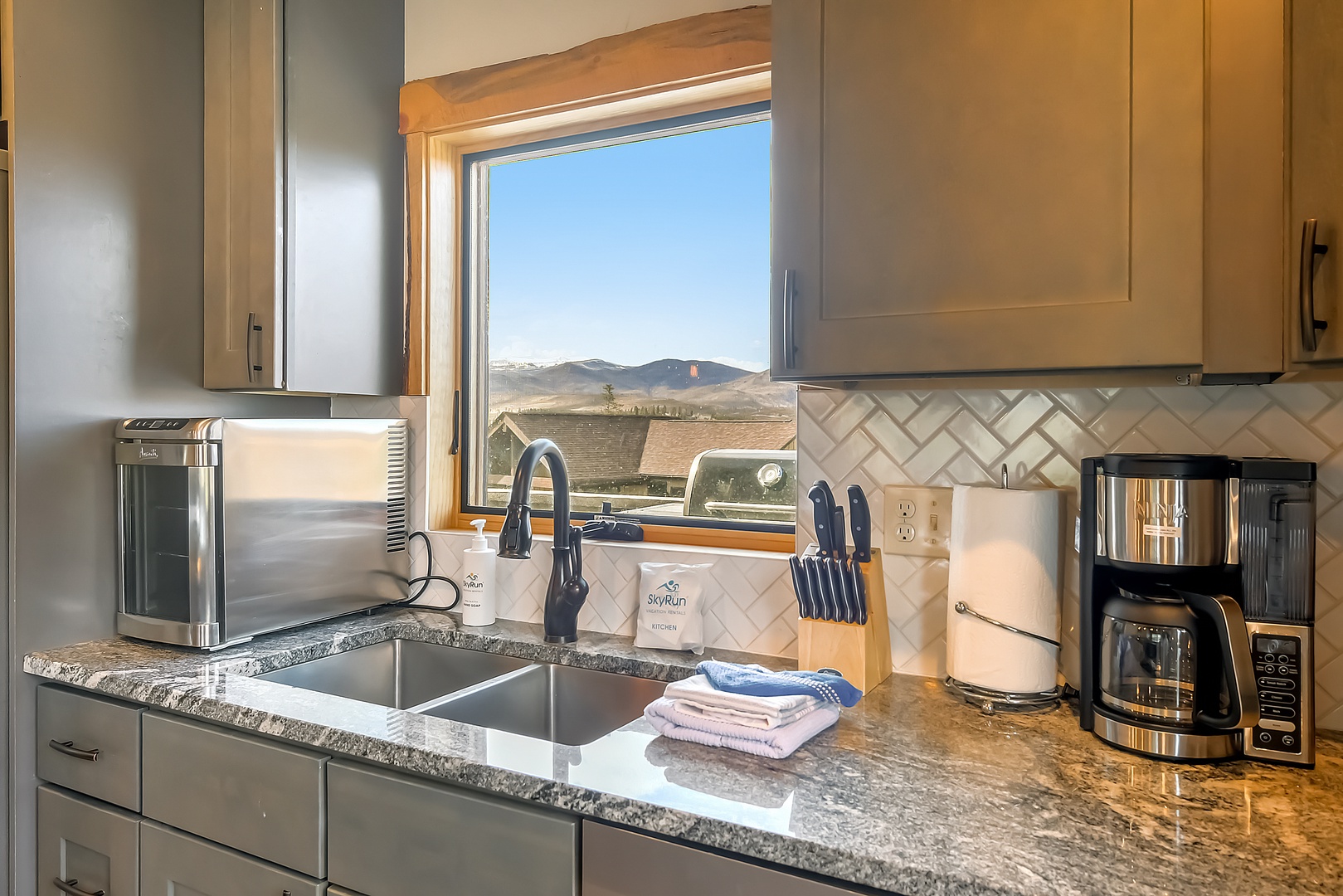 Prepare your morning coffee while soaking in stunning mountain vistas through the kitchen window—your culinary space overlooks breathtaking natural beauty.