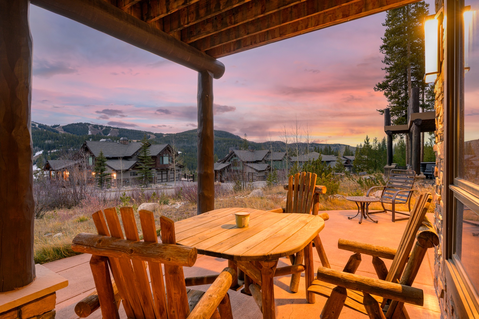 Relax on your private patio with rustic mountain views as sunset paints the sky in warm hues.