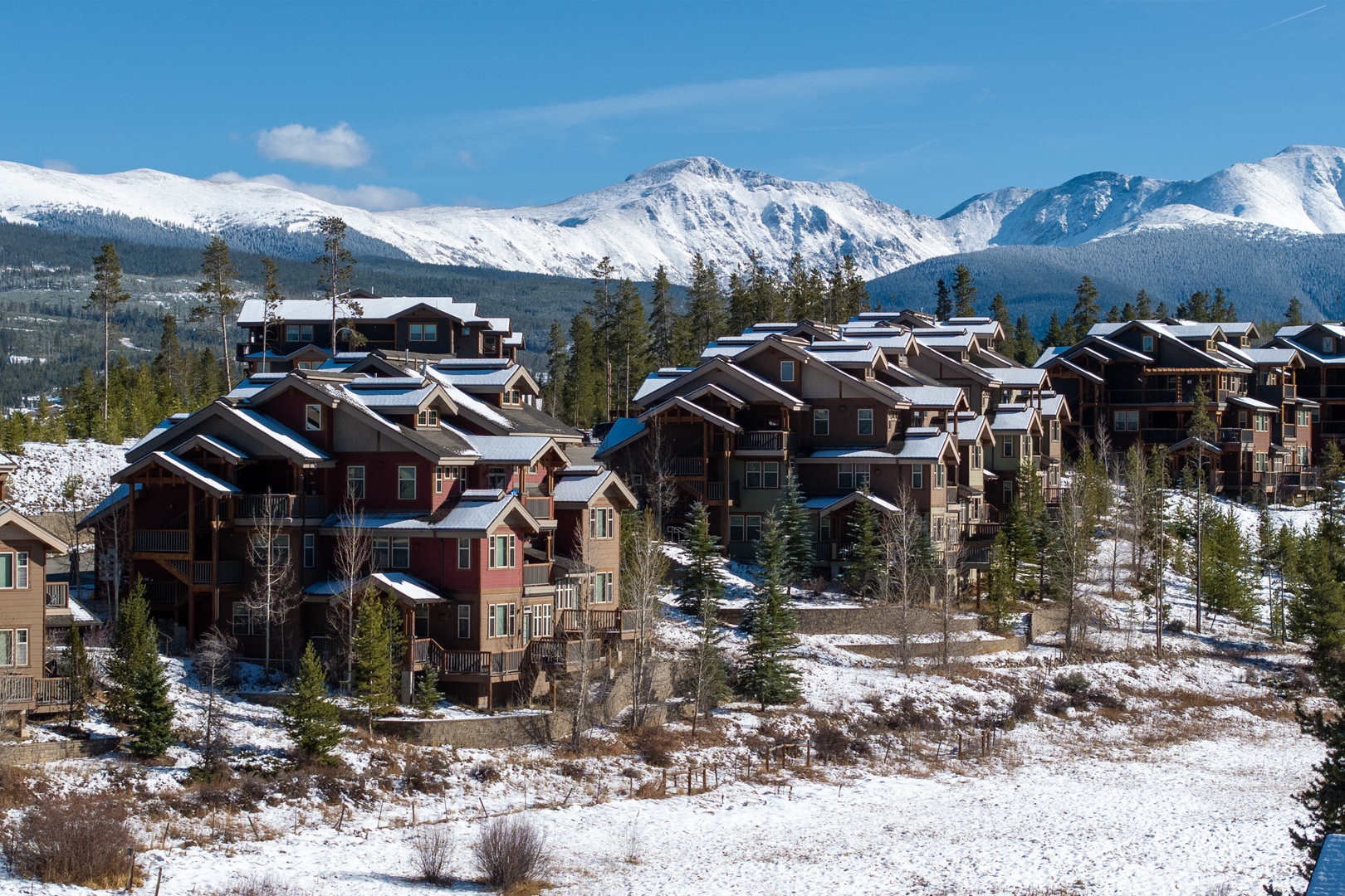 Nestled against towering snow-capped peaks, this mountain community offers stunning natural beauty and alpine charm, marking your arrival to a peaceful retreat surrounded by evergreen forests and winter wonder.