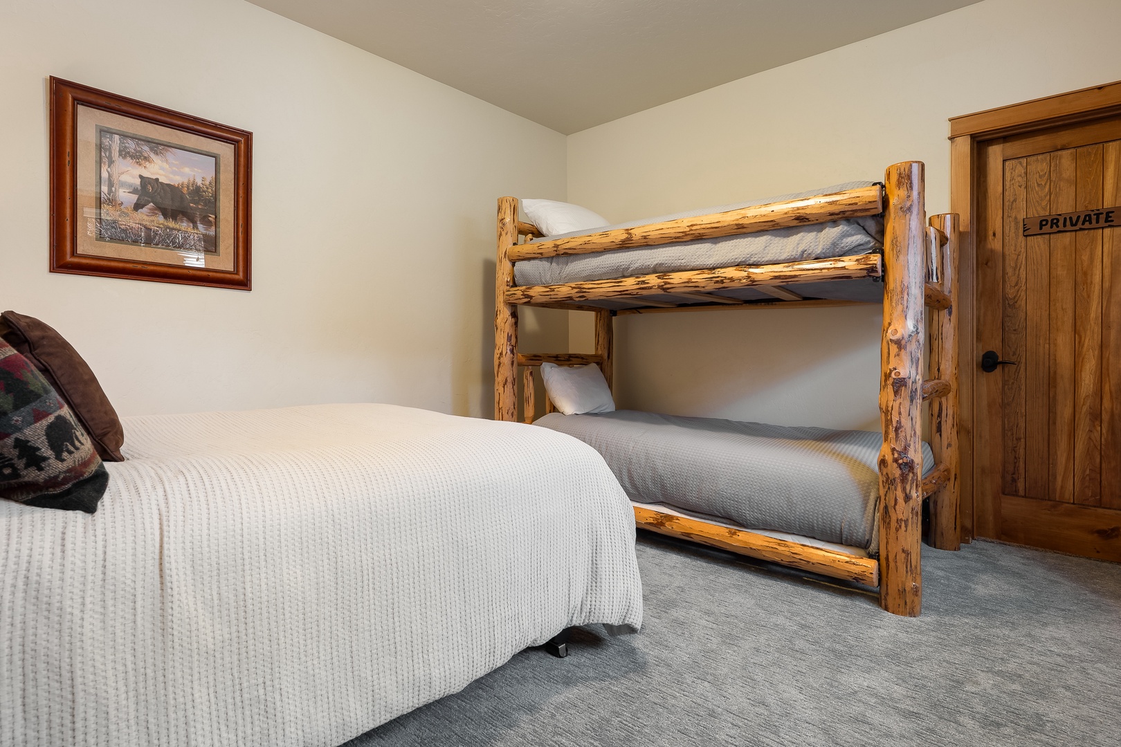 Your cozy bedroom features rustic log bunk beds and a full bed