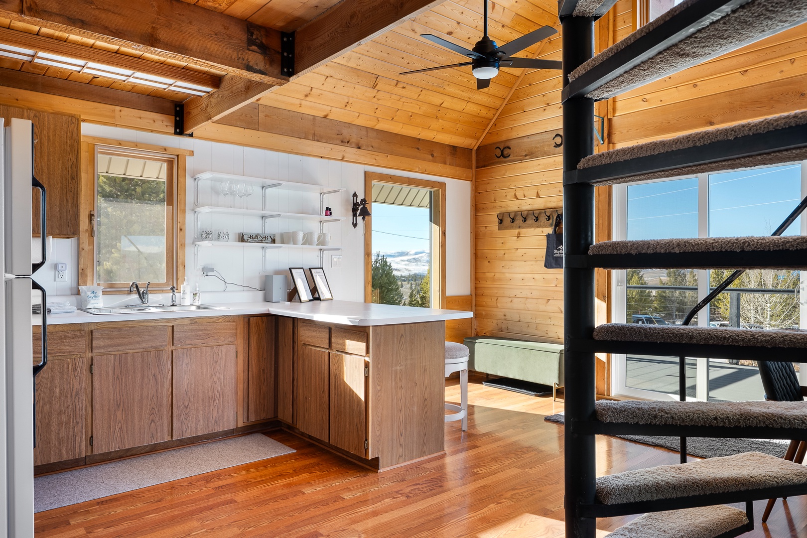 Your rustic kitchen features warm wood cabinets and mountain views, creating the perfect space for cooking memorable meals together.