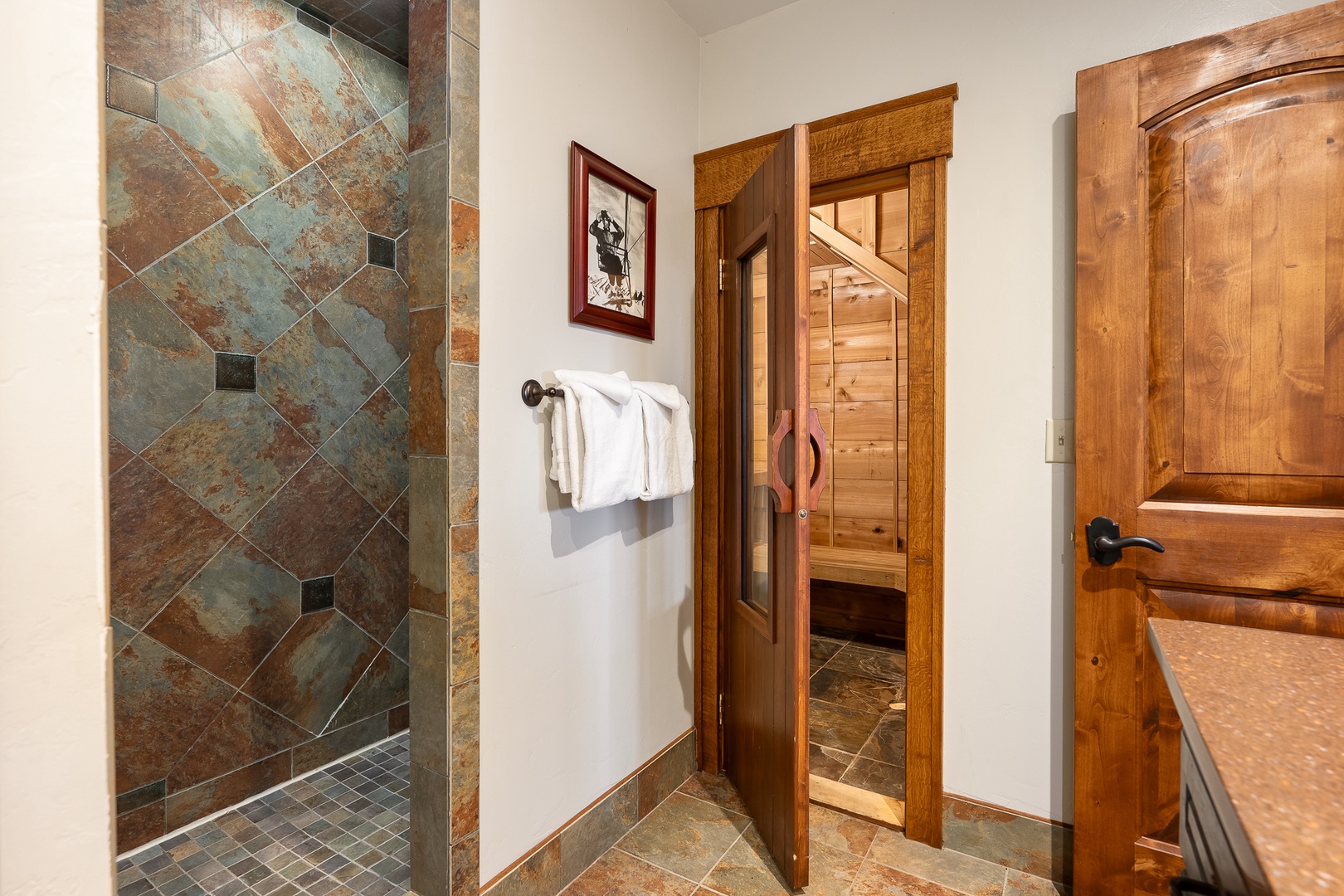 Unwind in your private spa retreat featuring a luxurious stone-tiled shower and authentic cedar sauna, creating the perfect mountain wellness sanctuary.