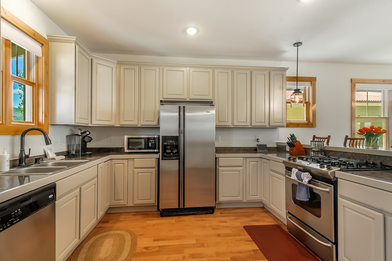 Your fully equipped kitchen features stainless steel appliances, ample counter space, and elegant cream cabinetry—perfect for preparing meals during your stay.