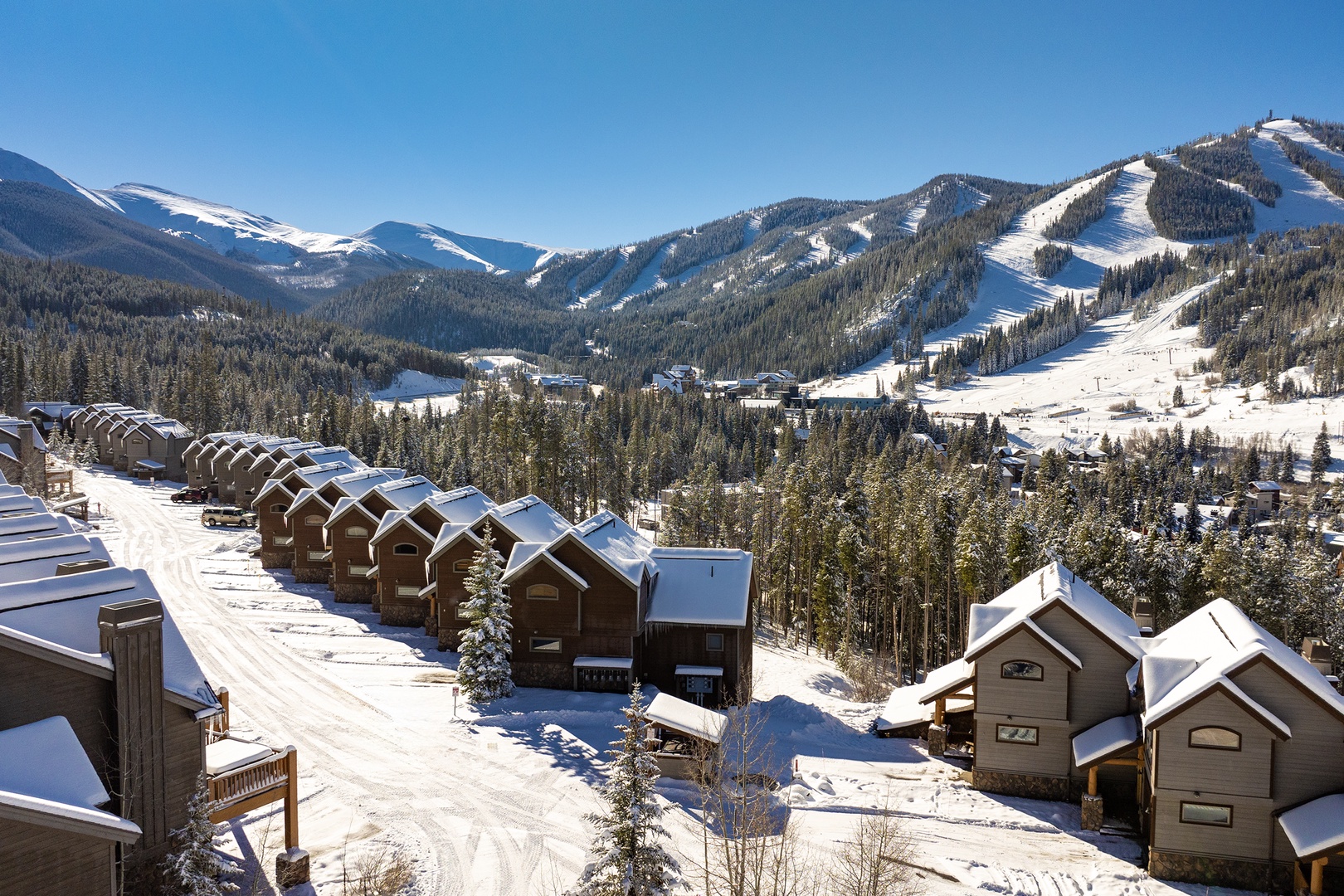 This alpine ski resort sits surrounded by snow-covered peaks and forested slopes, offering ski-in/ski-out access to pristine mountain terrain. Chairlifts and groomed runs await winter adventure seekers.