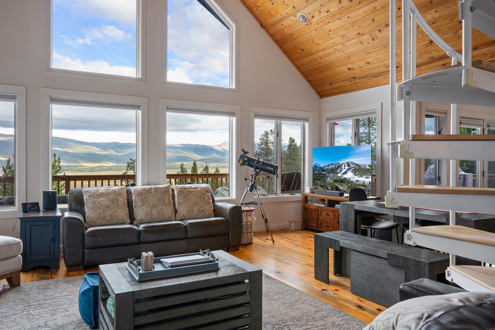Expansive mountain views pour through floor-to-ceiling windows, framing your retreat with natural beauty. Relax in the airy living space and stargaze from inside with the telescope.