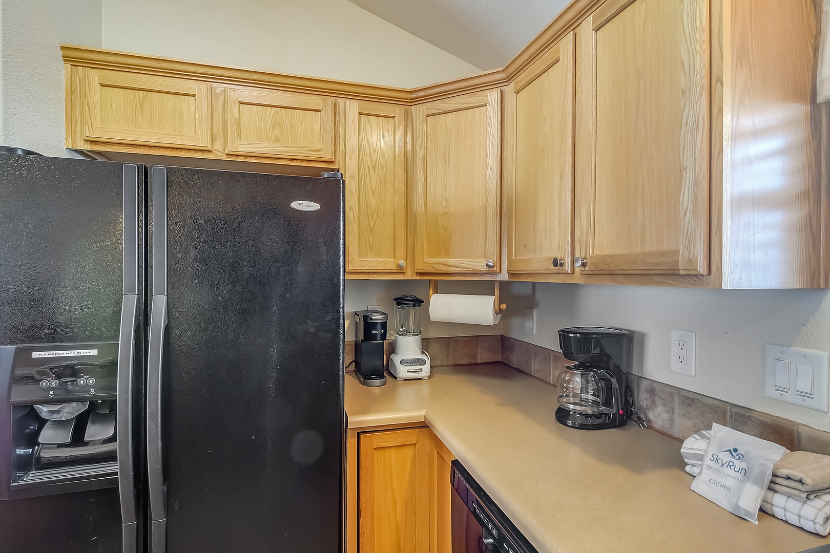 Your fully equipped kitchen awaits with warm wood cabinets, modern appliances, and everything you need for home-cooked meals during your stay.
