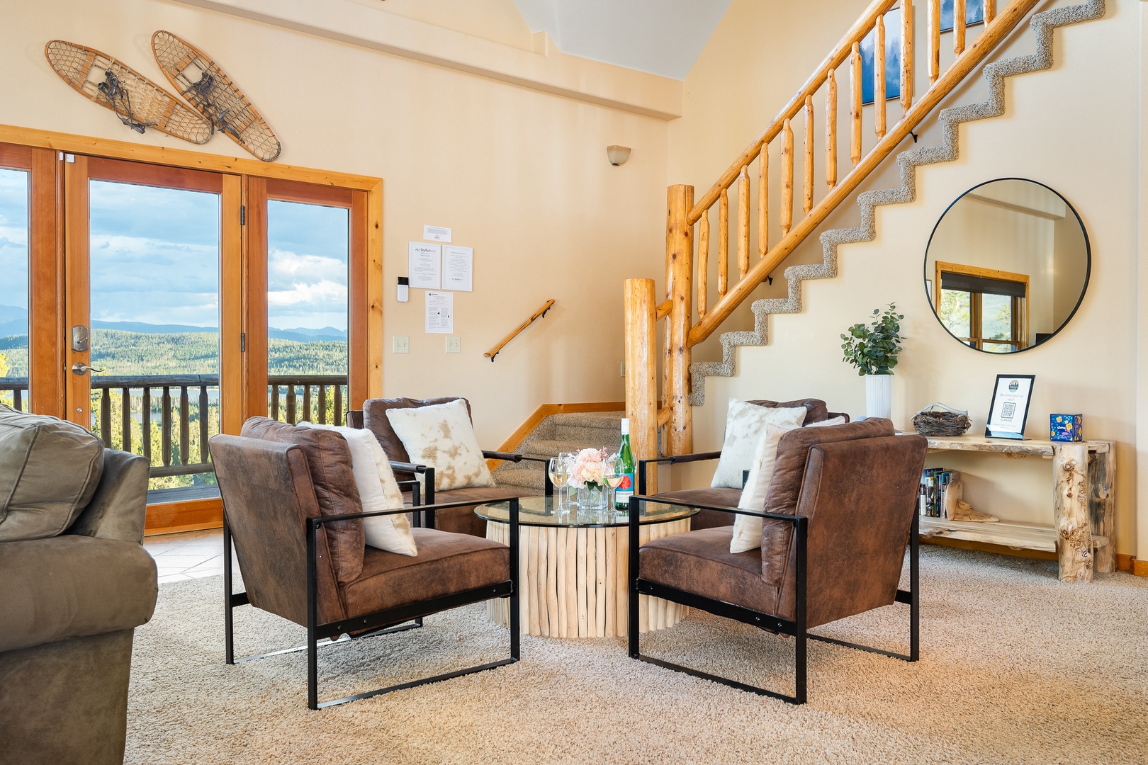 Settle into your cozy living space with plush seating, natural light streaming through the glass doors, and those stunning mountain and forest views waiting just beyond the balcony. Rustic charm meets comfort in every detail.