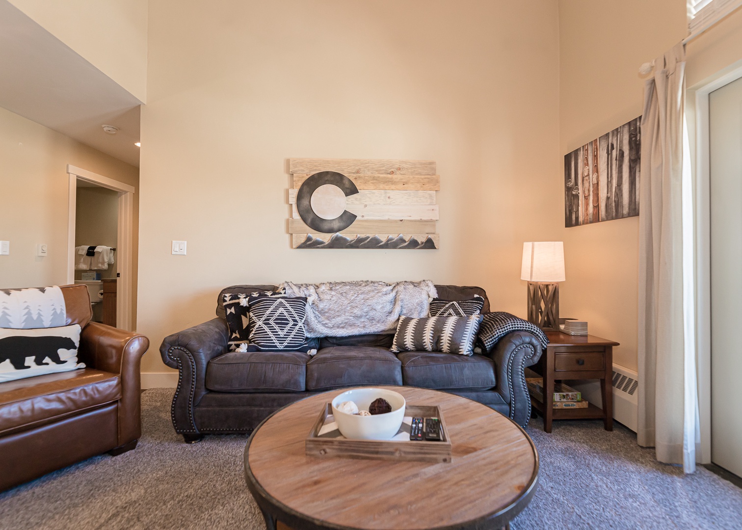 Sink into this cozy living room's plush sofa and unwind with rustic Colorado charm surrounding you.