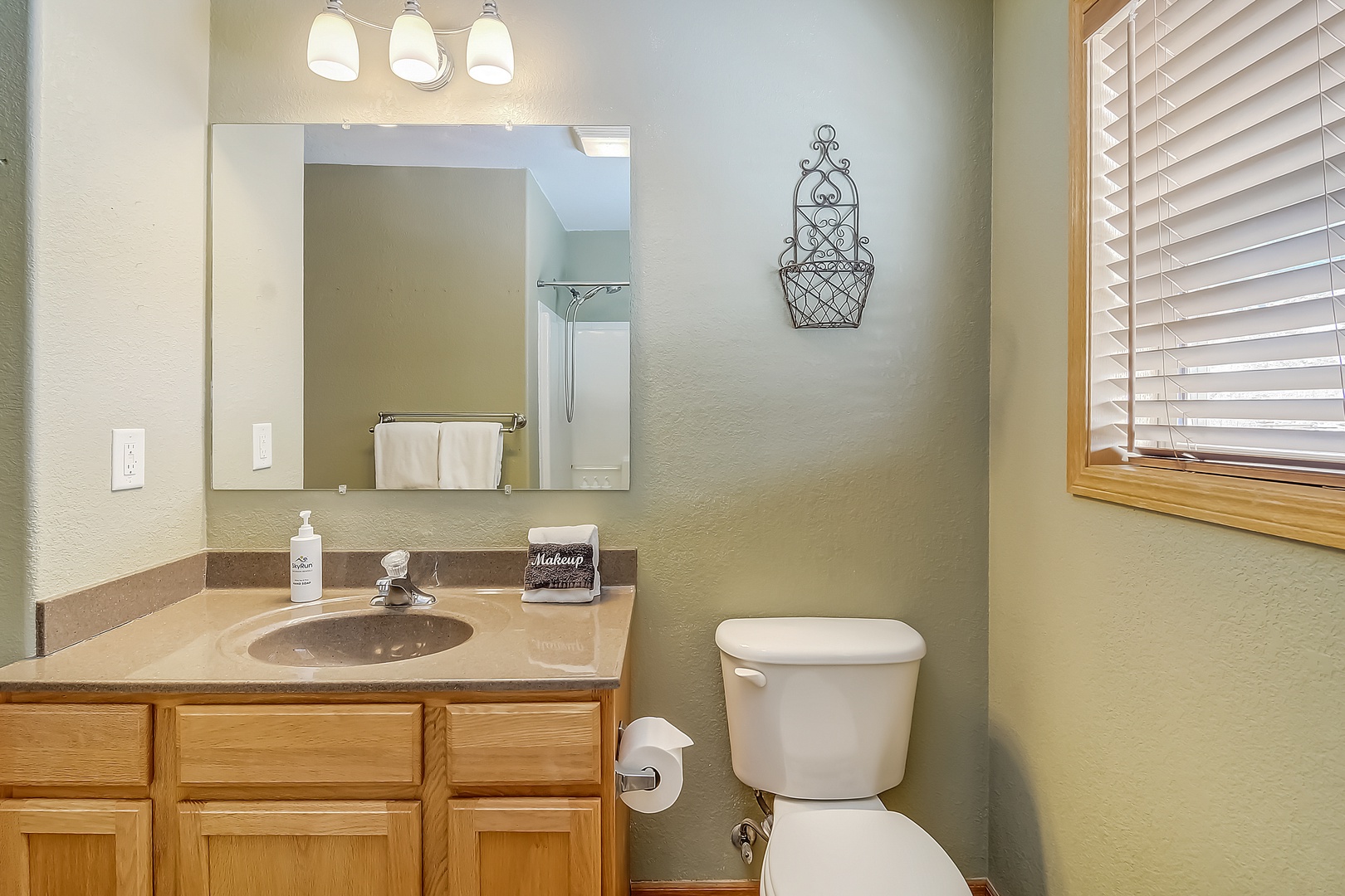 Freshen up in your well-appointed bathroom with warm wood vanity, quality fixtures, and thoughtful amenities.