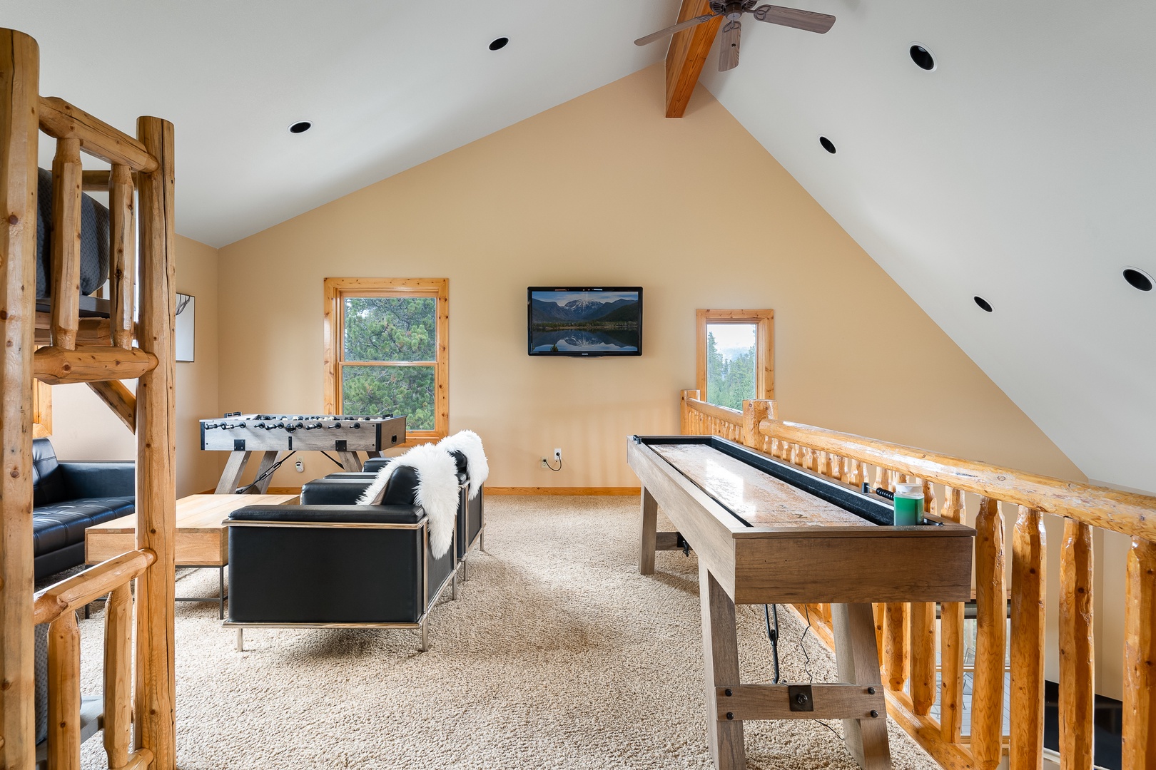 Your private upstairs loft beckons with a foosball table, shuffleboard, cozy seating, and bunk beds