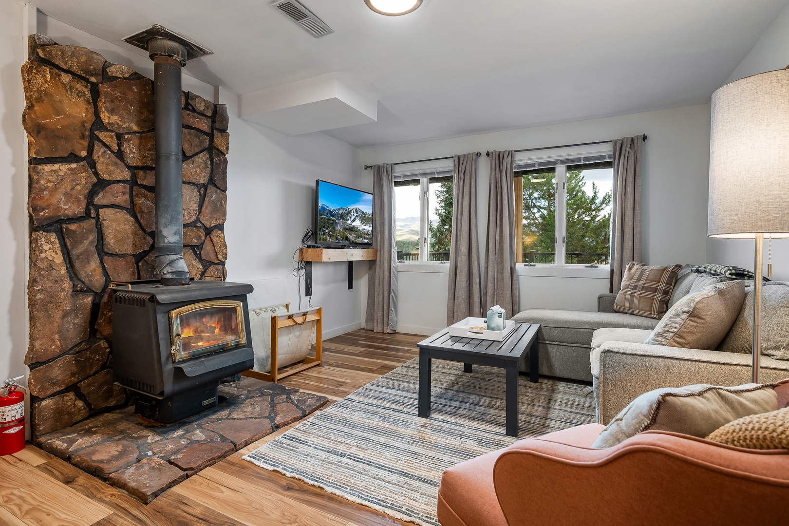 Lower level living area with a cozy wood burning stive