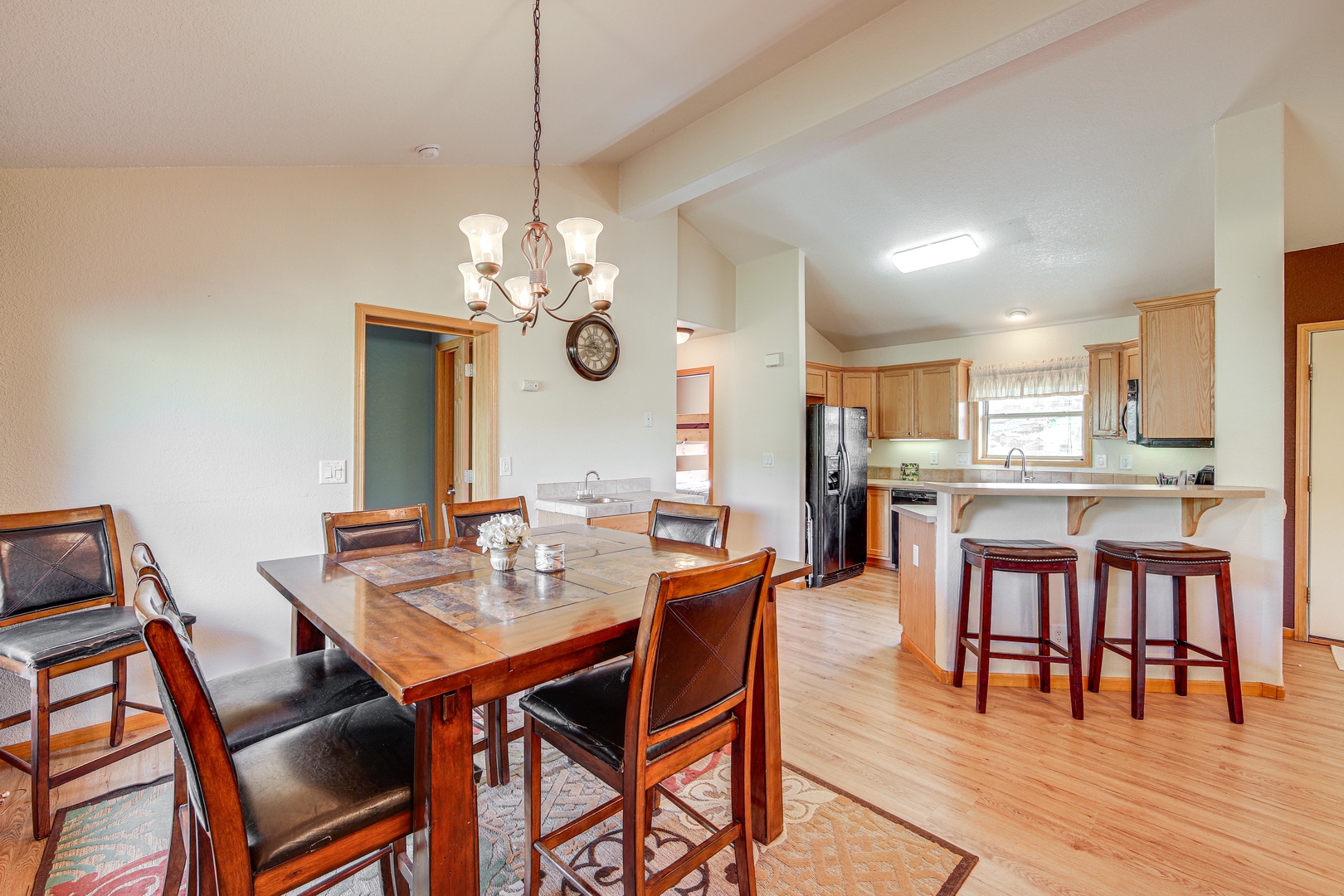 Your open-plan kitchen and dining area creates perfect moments for family meals with warm wood finishes and cozy lighting.