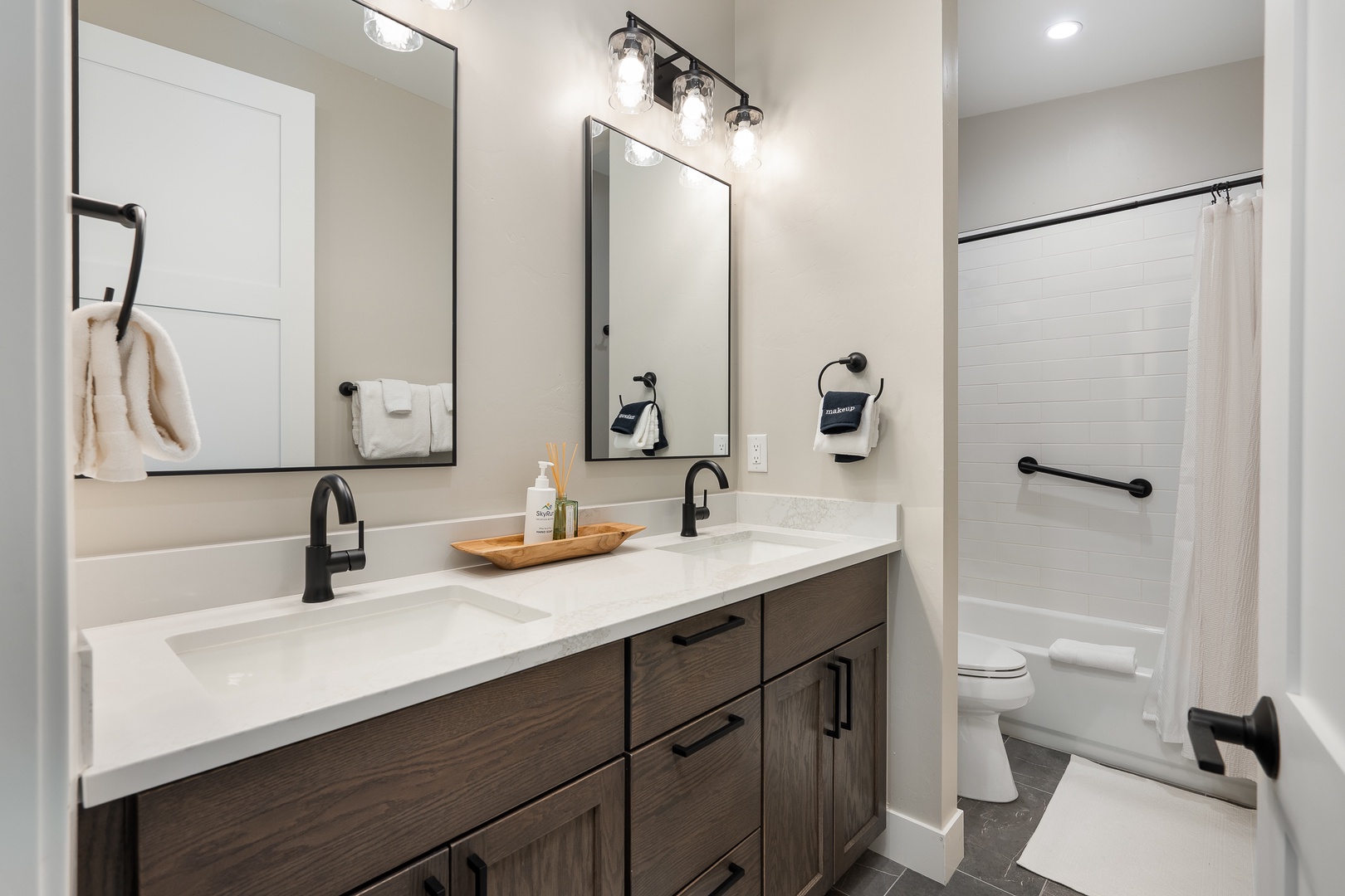 Step into your private bathroom where modern style meets comfort. Fresh towels, dual sinks, and thoughtful amenities await, all designed with your convenience in mind.