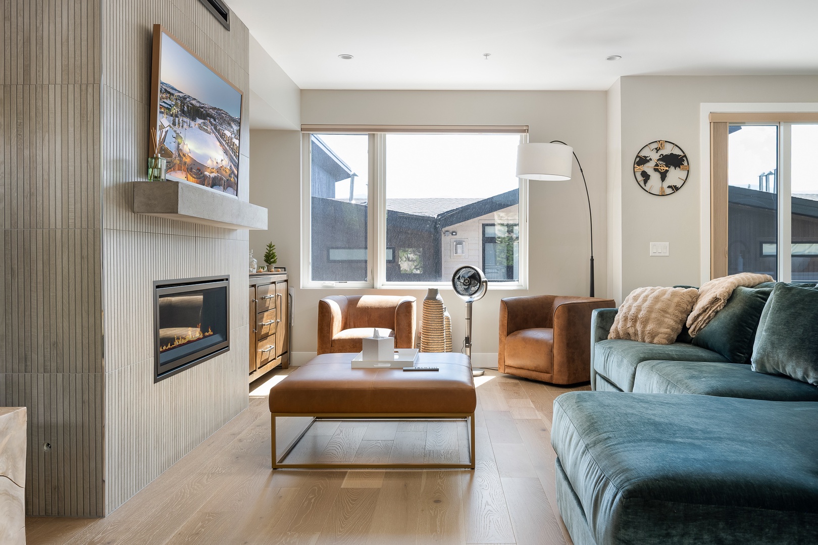 Sink into plush seating by your private fireplace, where warm tones and natural light create the perfect space for relaxing after a day of adventure.