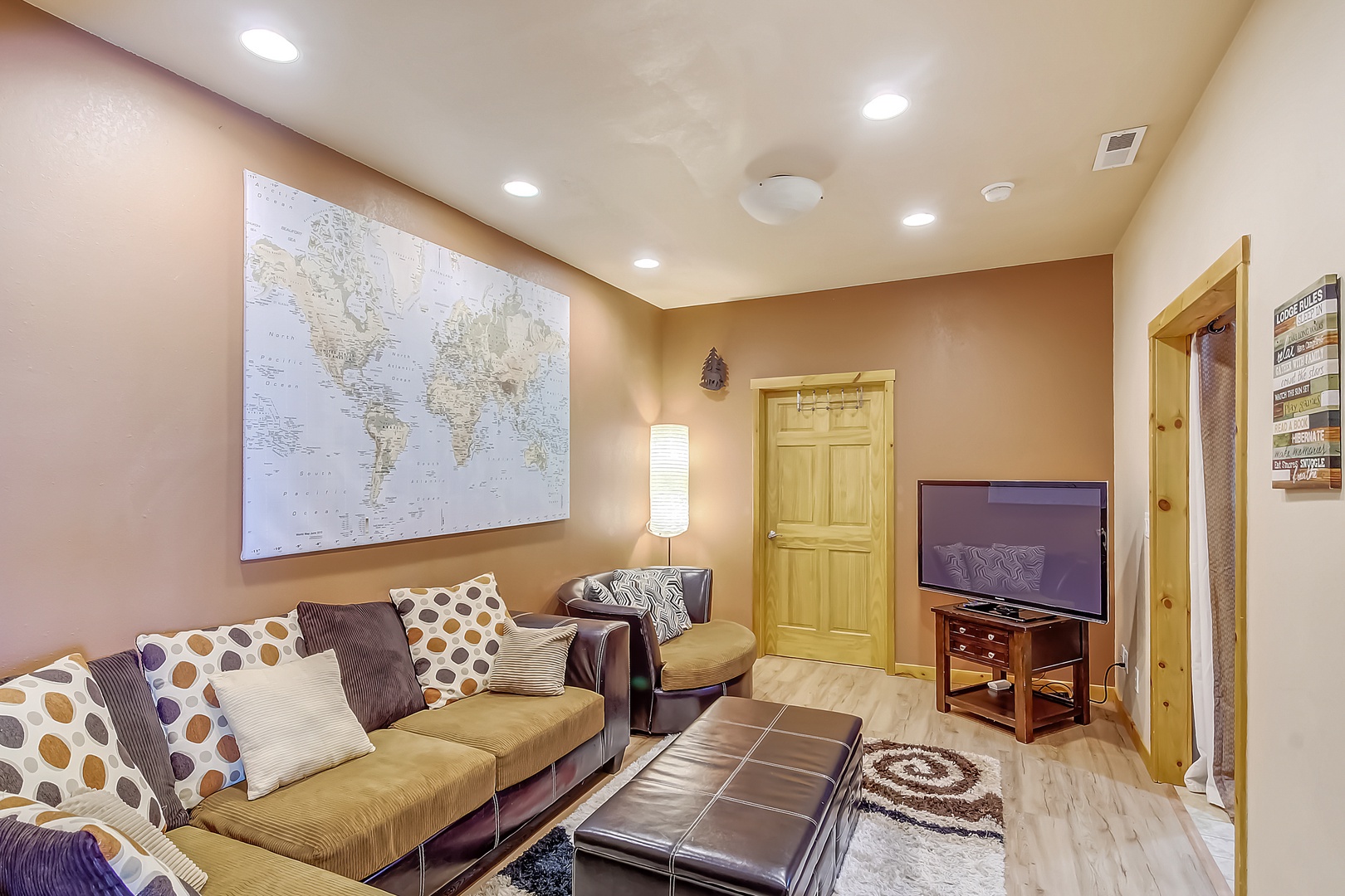 Unwind in your inviting living room with plush seating and entertainment center, perfect for relaxing evenings after exploring.