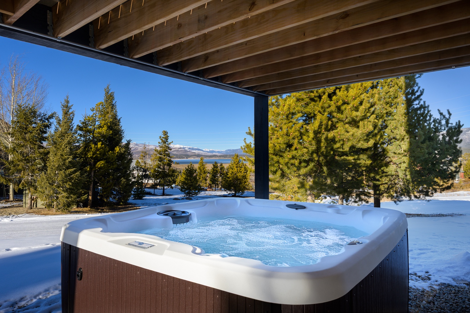 Soak in your private hot tub while gazing at snow-capped mountains and pristine lake views—pure alpine bliss awaits.