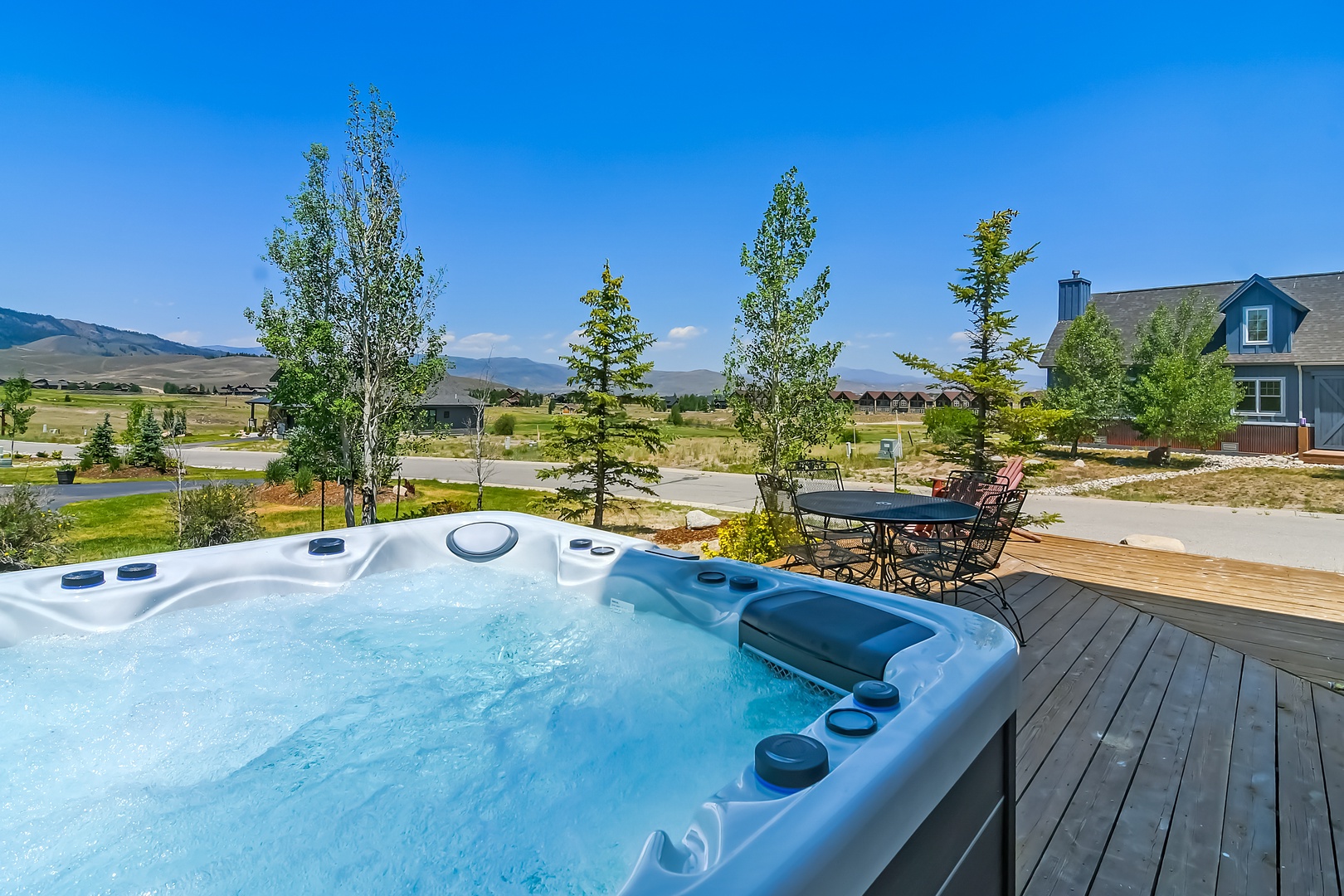 Soak in the bubbling hot tub while gazing at mountains and open skies, then step out to dine alfresco at the outdoor table beneath swaying trees.