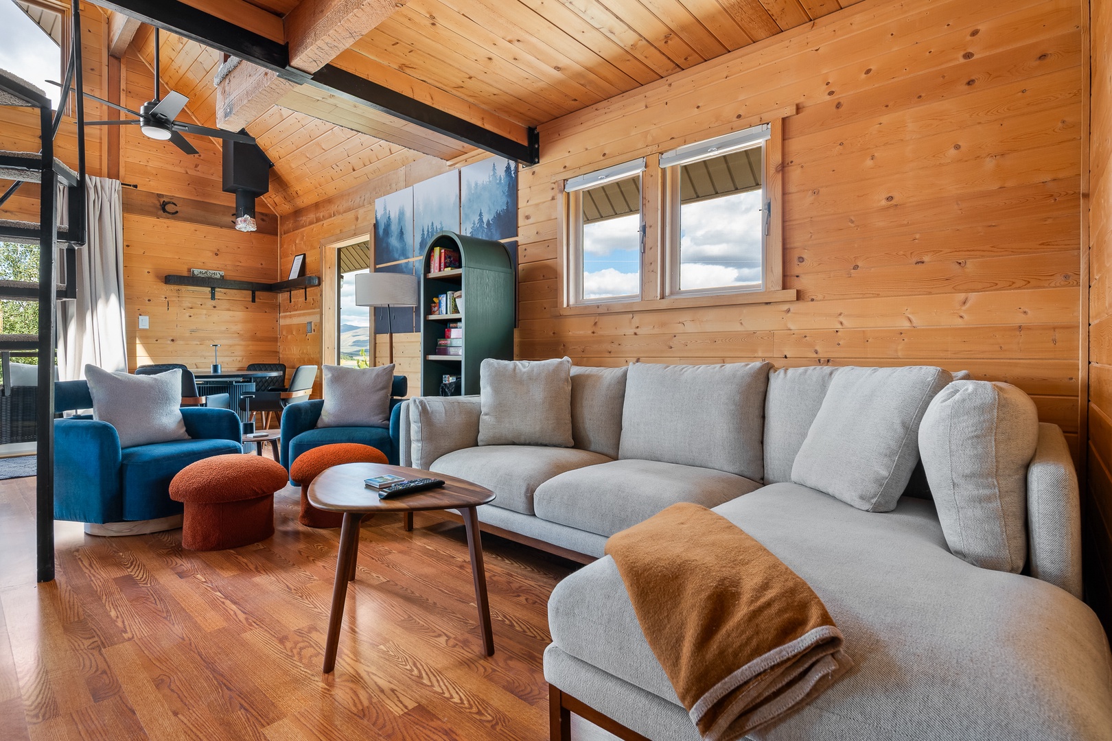 Sink into your plush living room and feel the warmth of natural wood surrounding you. Vaulted ceilings and big windows flood the space with light, while cozy seating invites you to relax after a day of adventure.