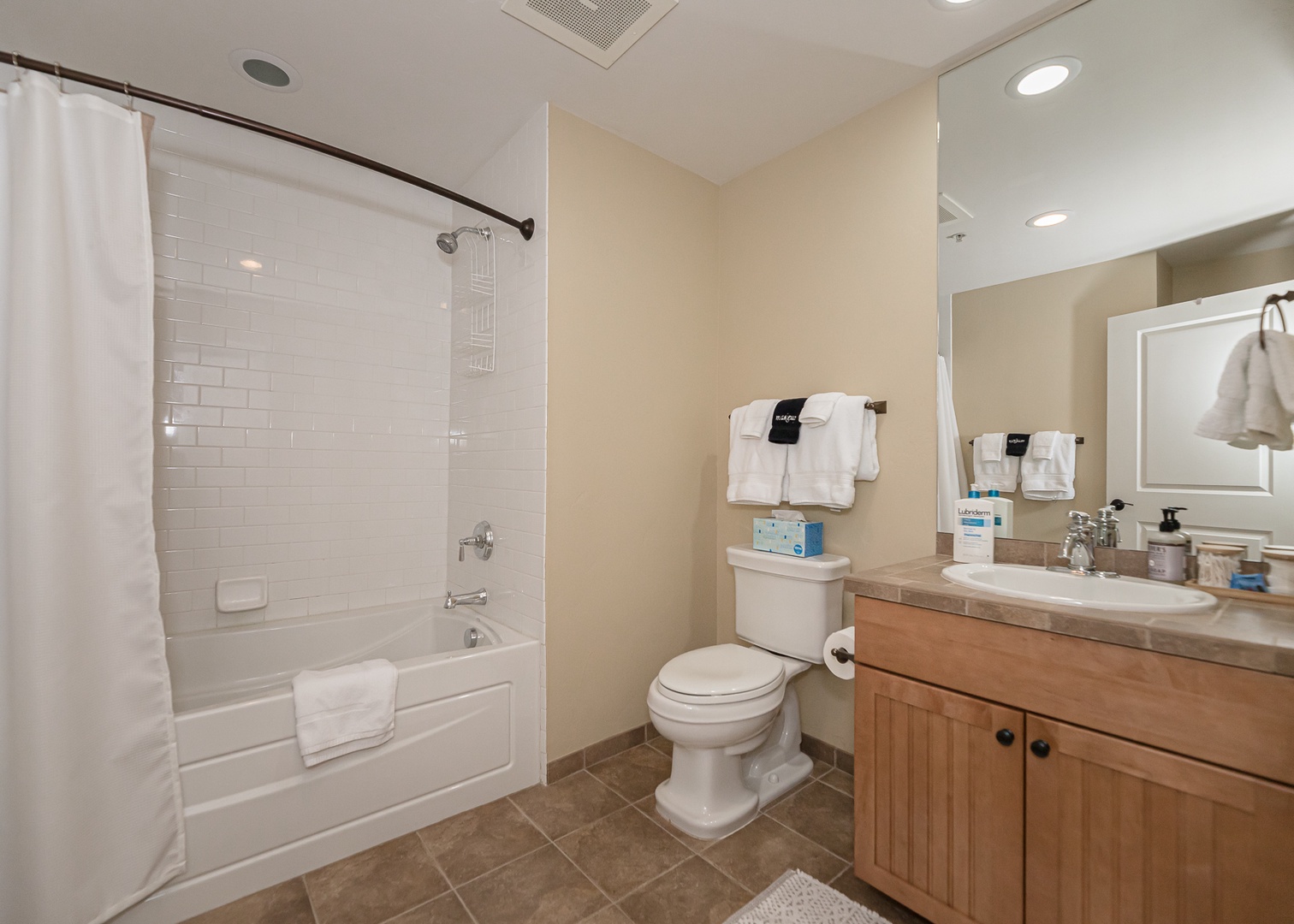Your spacious bathroom features a relaxing tub-shower combo, granite countertops, and all essentials for a comfortable stay.