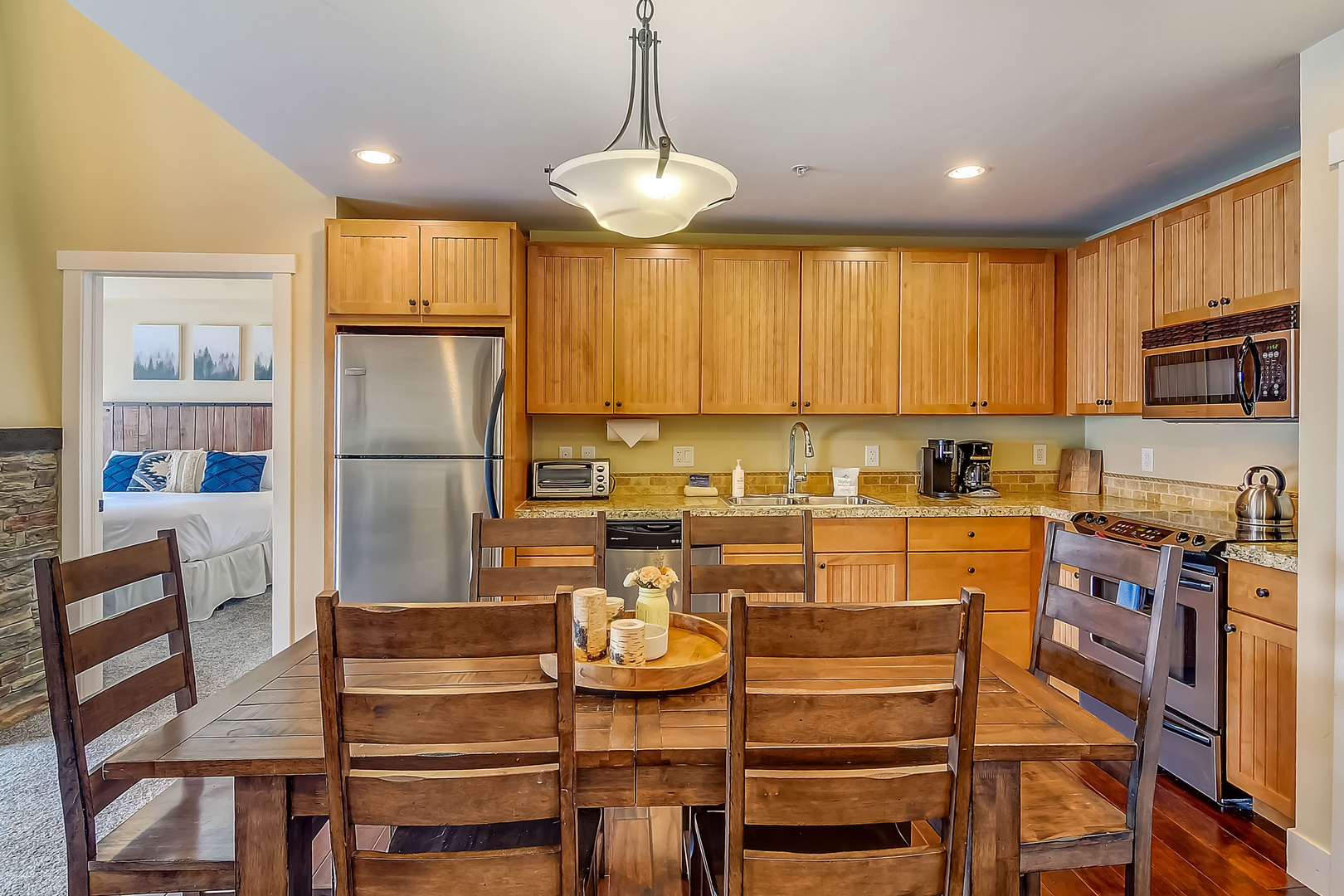 Prepare delicious meals in your fully equipped kitchen with granite counters, stainless appliances, and warm wood cabinets.