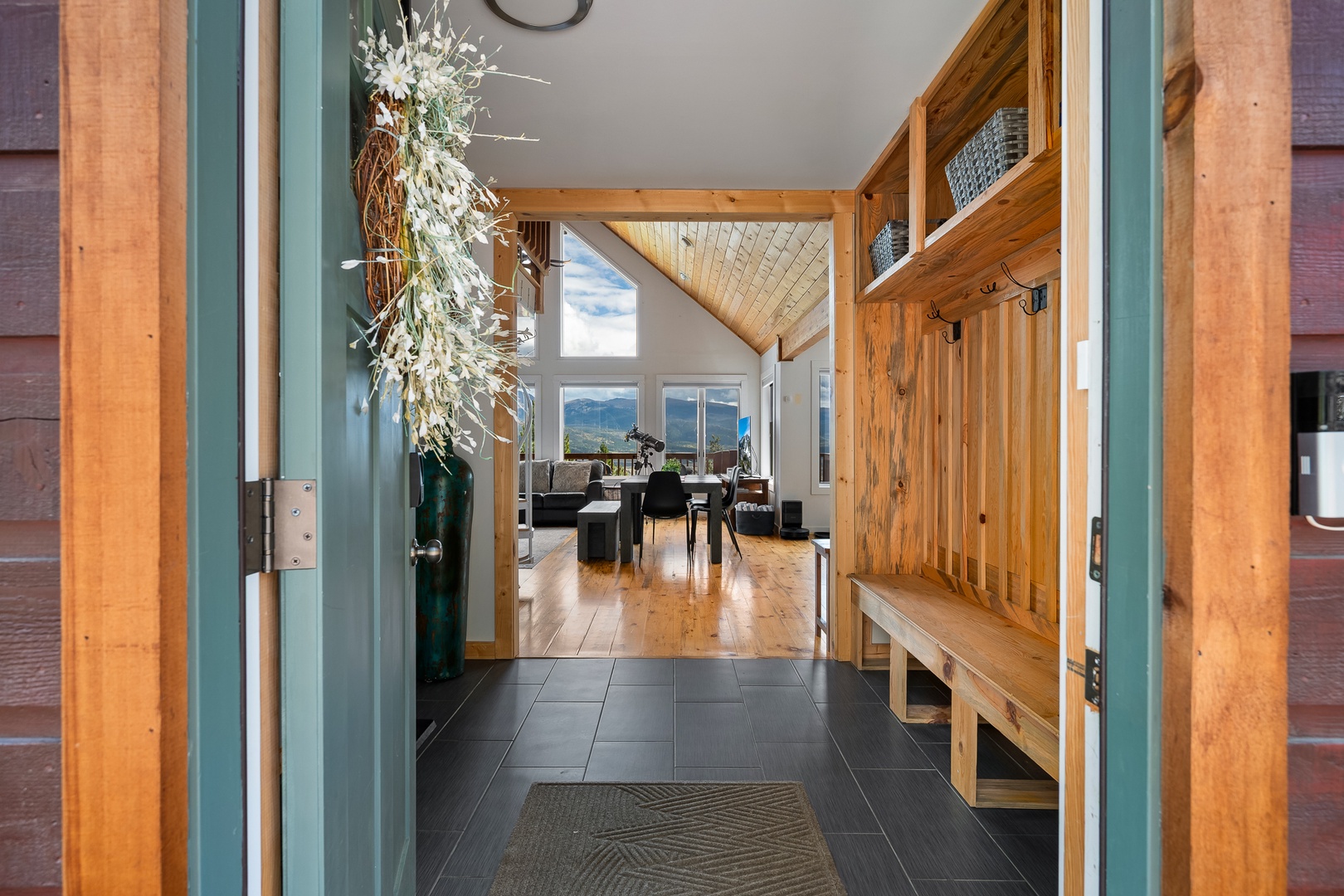 Step through the door and breathe in the mountain air. Natural wood and soaring ceilings guide your eye to sweeping views beyond, while thoughtful storage keeps your gear ready for your next adventure.