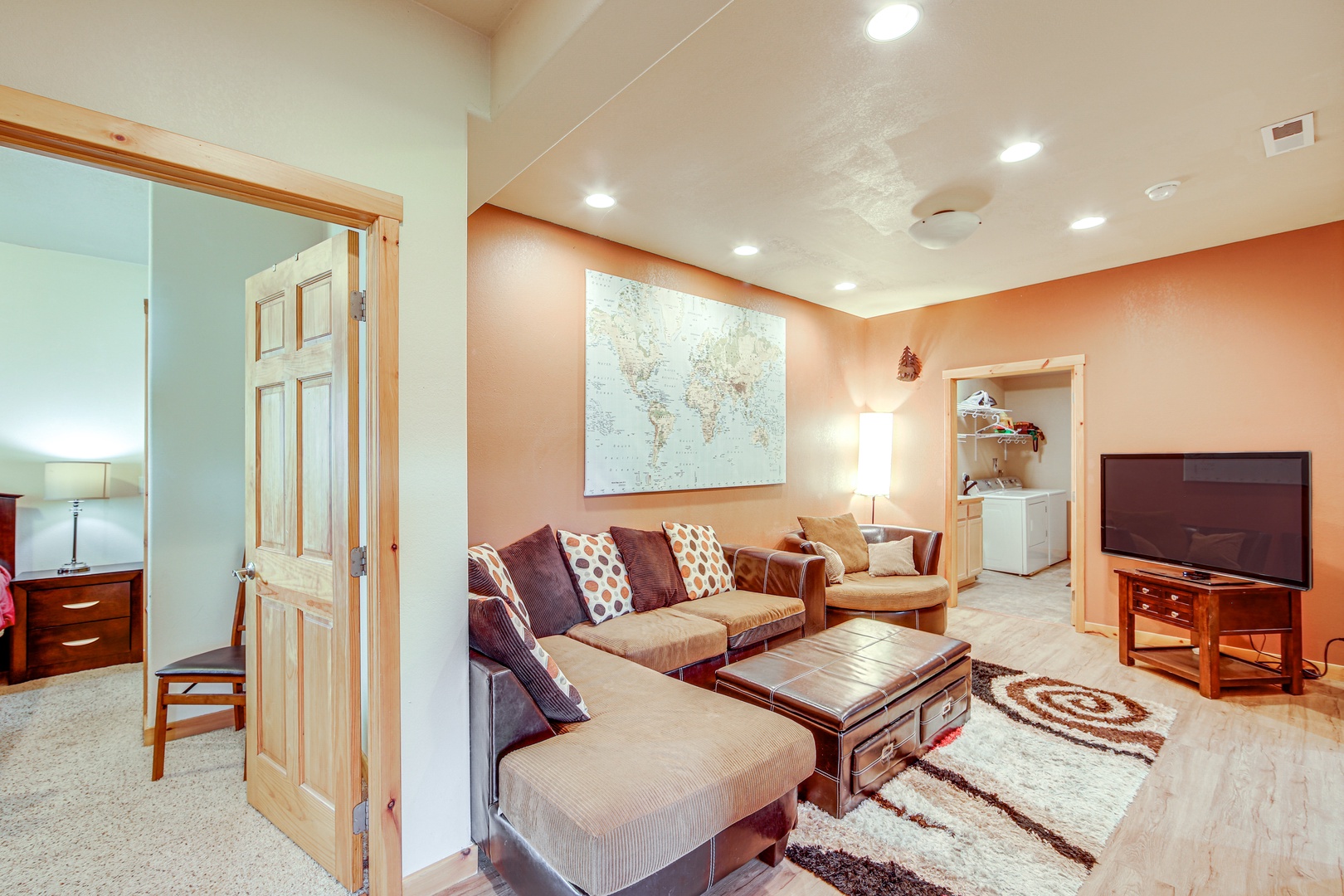 Unwind in your spacious living room featuring plush sectional seating, entertainment center, and warm earth tones that create the perfect atmosphere for relaxation.