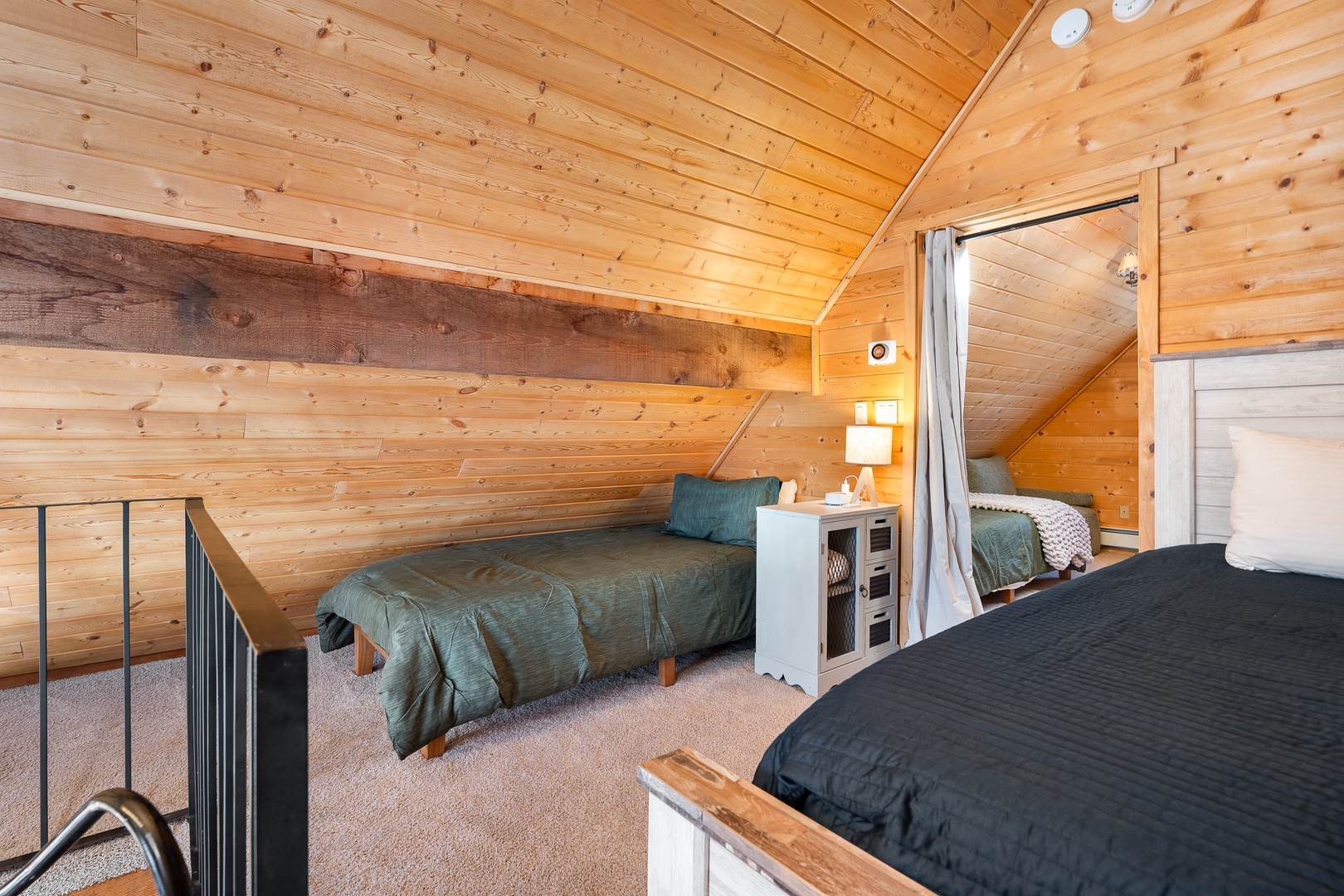 Cozy loft bedroom with warm wood beams creates your perfect mountain retreat atmosphere for restful nights.