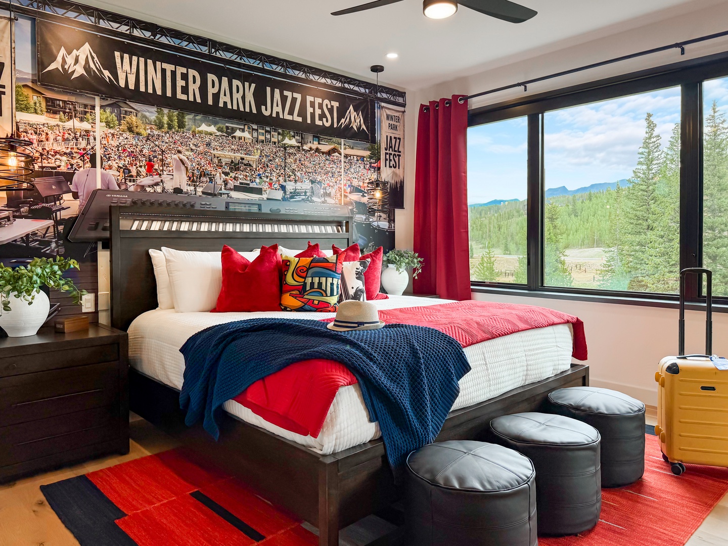 Your private retreat showcases bold décor, plush bedding, and floor-to-ceiling windows framing stunning mountain and forest views. Relax in modern comfort surrounded by natural beauty.
