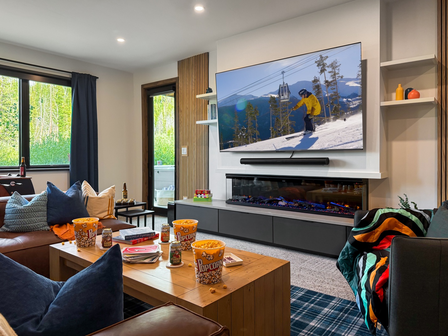 Settle in for movie night or aprés-ski relaxation in your cozy living room, where a sleek fireplace and plush seating invite you to unwind after your mountain adventures.
