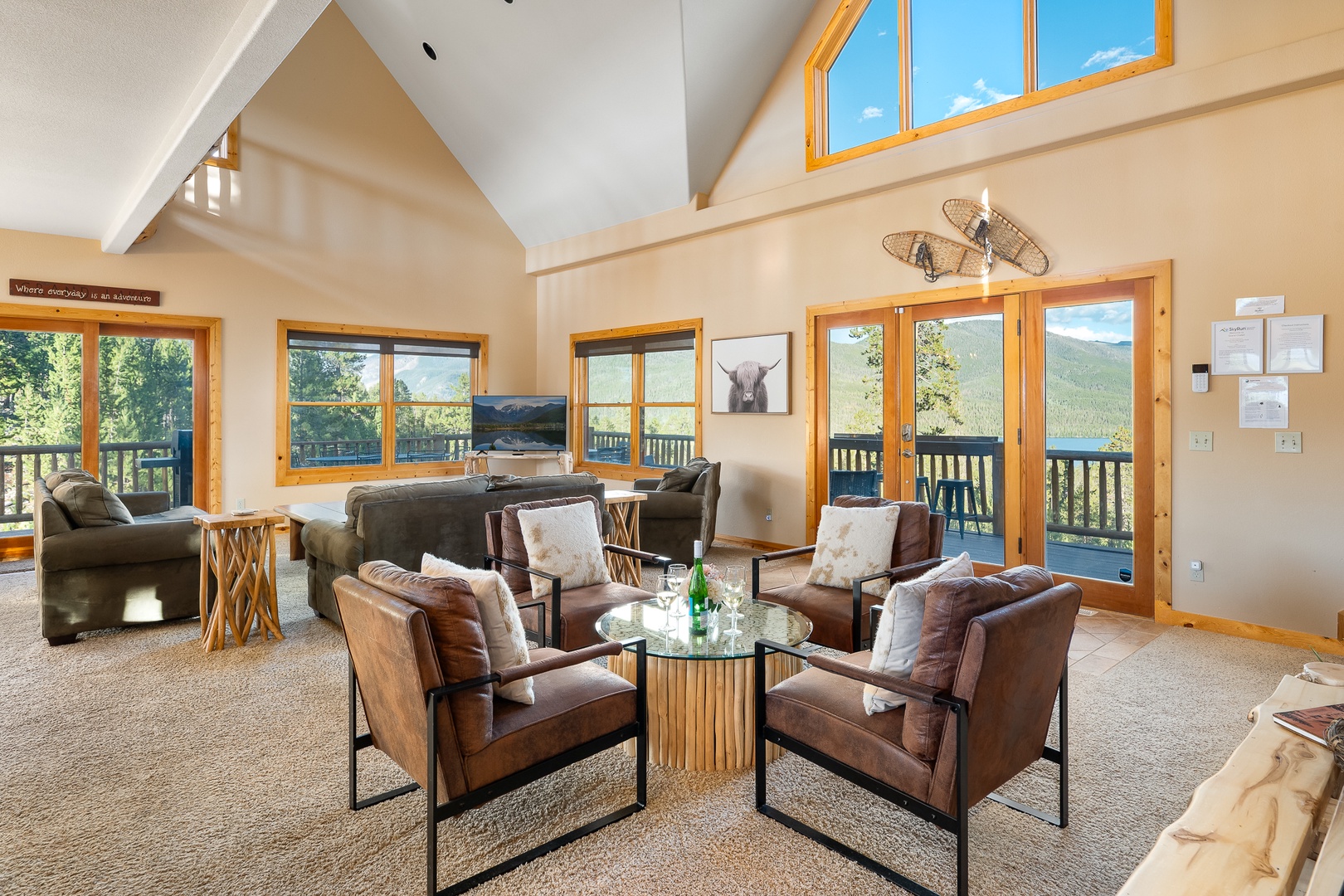 Gather with friends and family in this soaring living space, where mountain views pour through floor-to-ceiling windows and a balcony beckons you to breathe in the fresh alpine air.