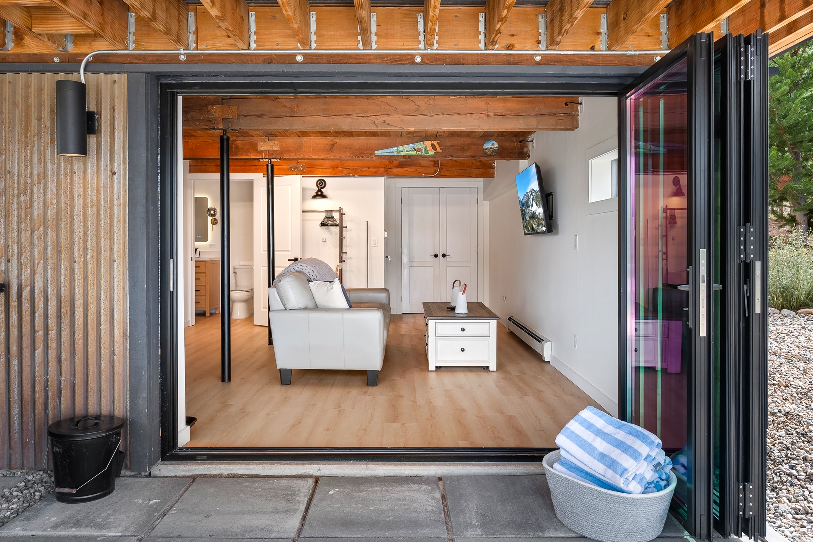 Step through wide folding doors into your bright open primary suite.