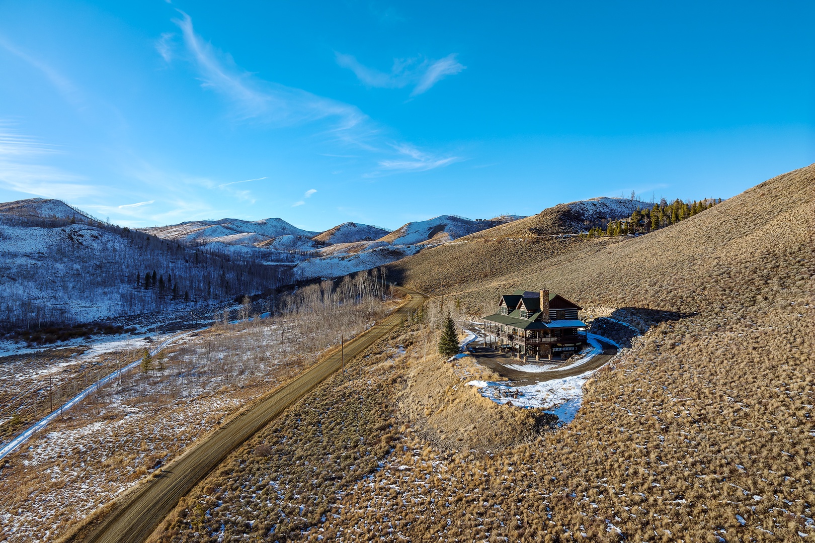 Remote mountain retreat nestled among snowy peaks and rolling hills, offering complete privacy and stunning wilderness views.