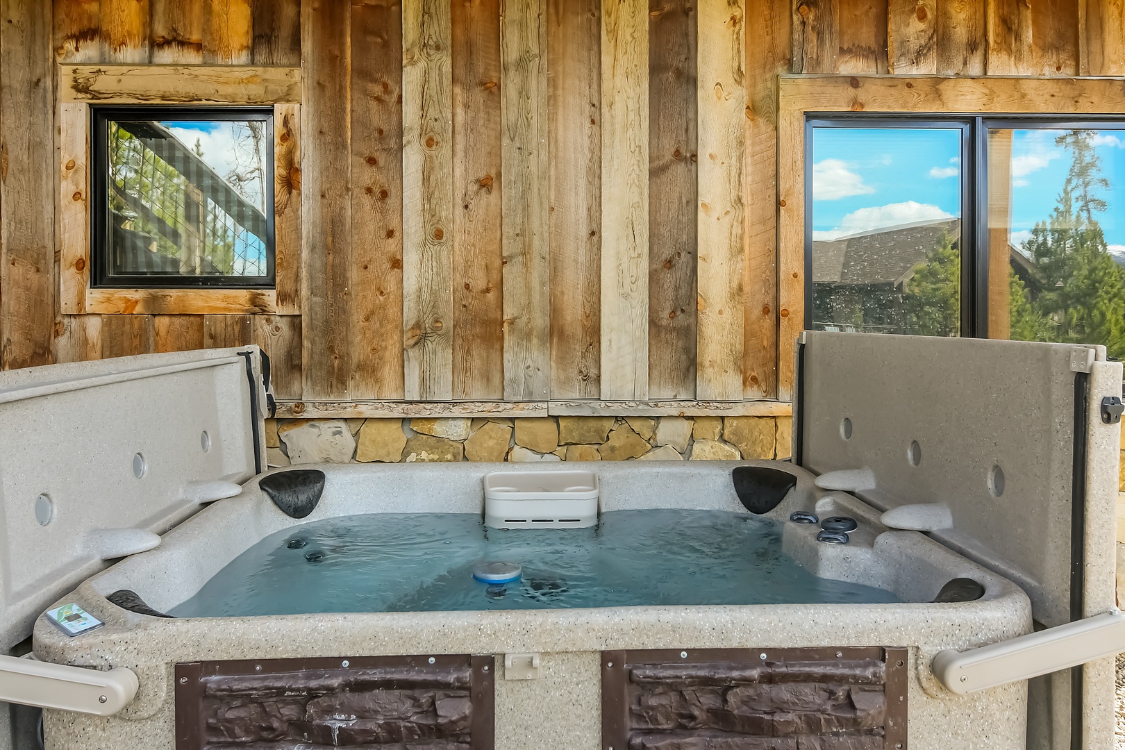 Soak away your worries in this private hot tub, surrounded by rustic wood and stone with mountain views through large windows.