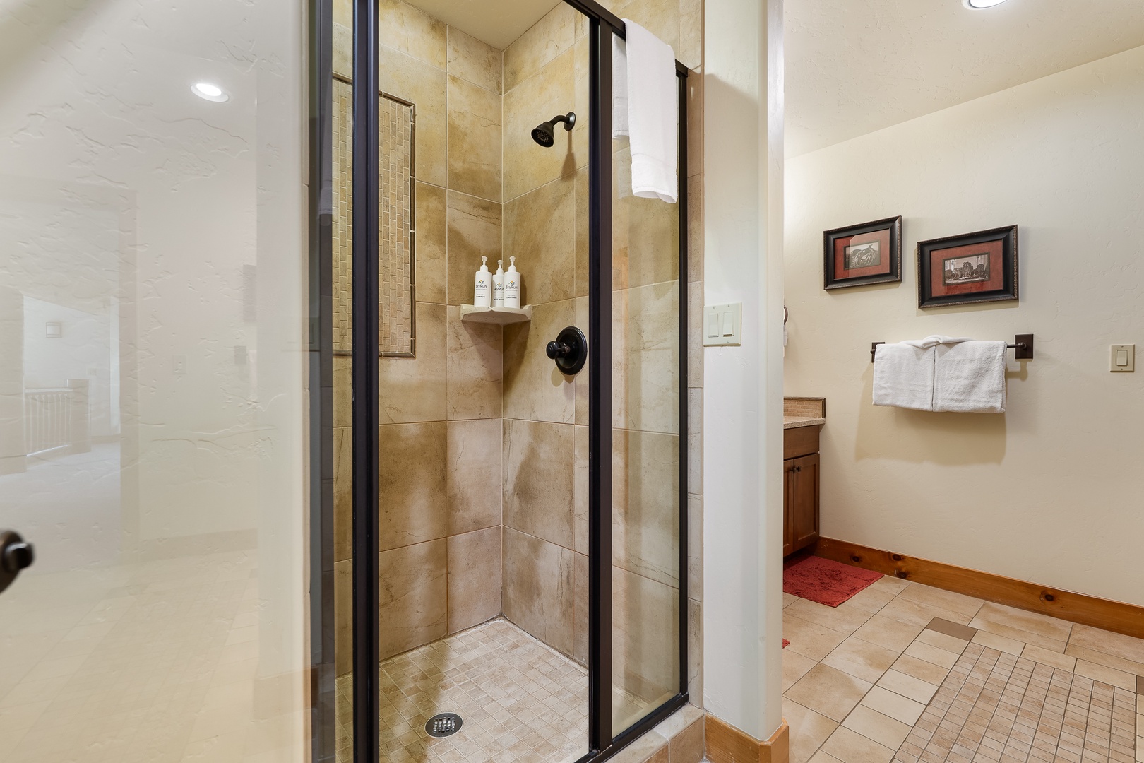 Step into your private spa-like bathroom with elegant stone tiles and a luxurious glass-enclosed shower perfect for unwinding after your adventures.
