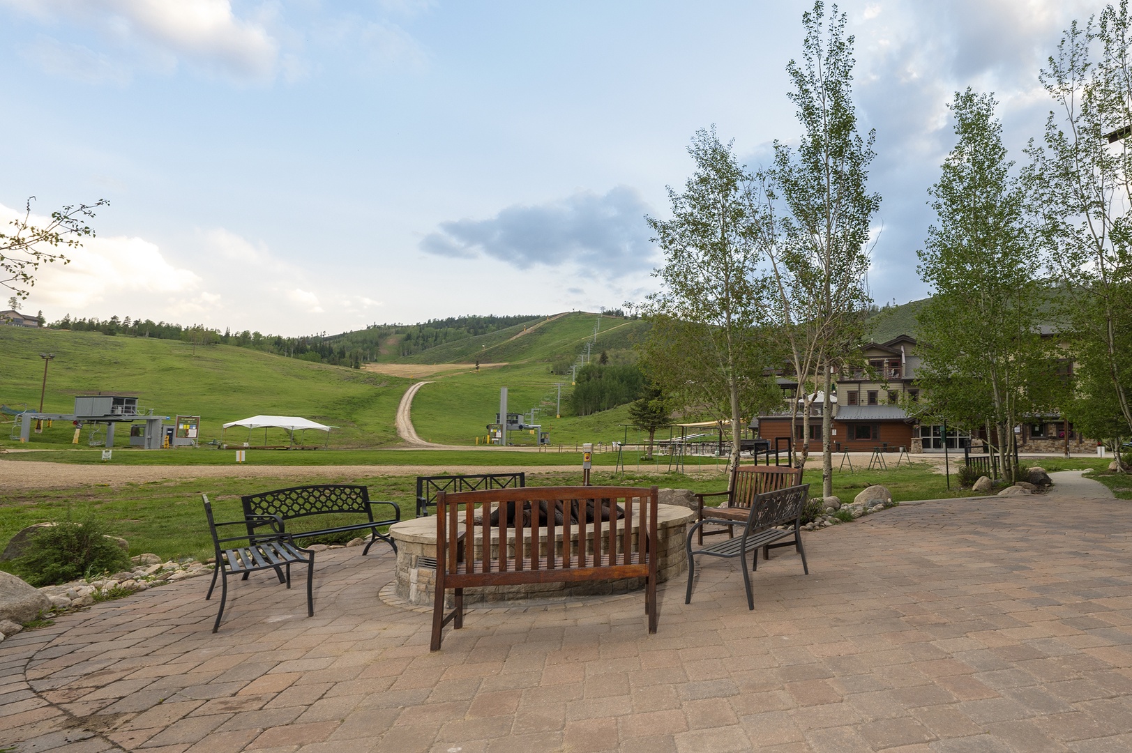 The property sits at the base of a scenic mountain area, surrounded by rolling green hills and natural landscapes, offering a peaceful retreat setting.