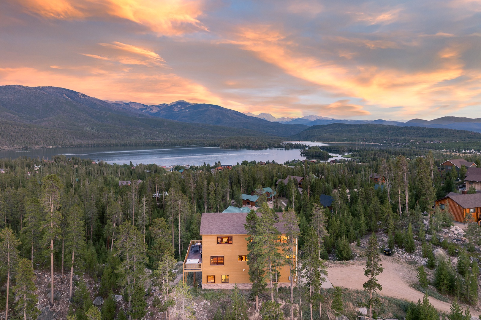 Nestled among tall pines with a serene lake and majestic mountains nearby, this property offers a peaceful escape surrounded by natural beauty.