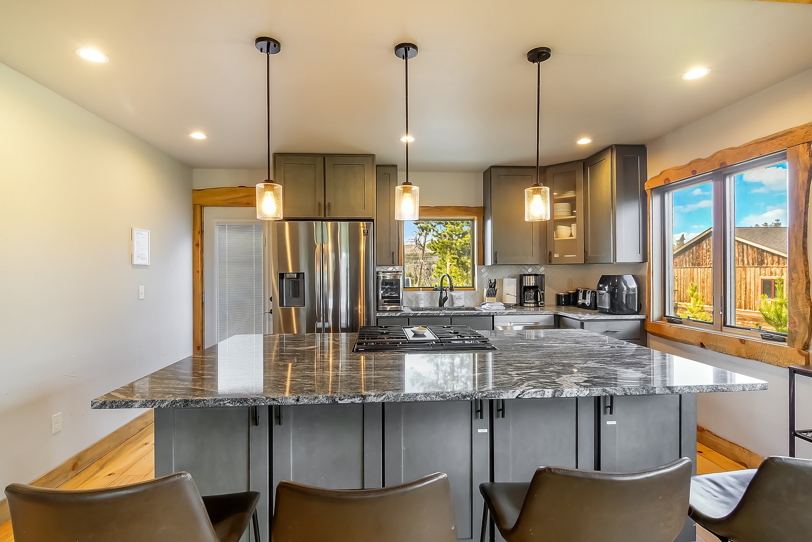 Your chef's dream awaits—gleaming granite counters, premium stainless appliances, and pendant lighting create the perfect culinary haven.