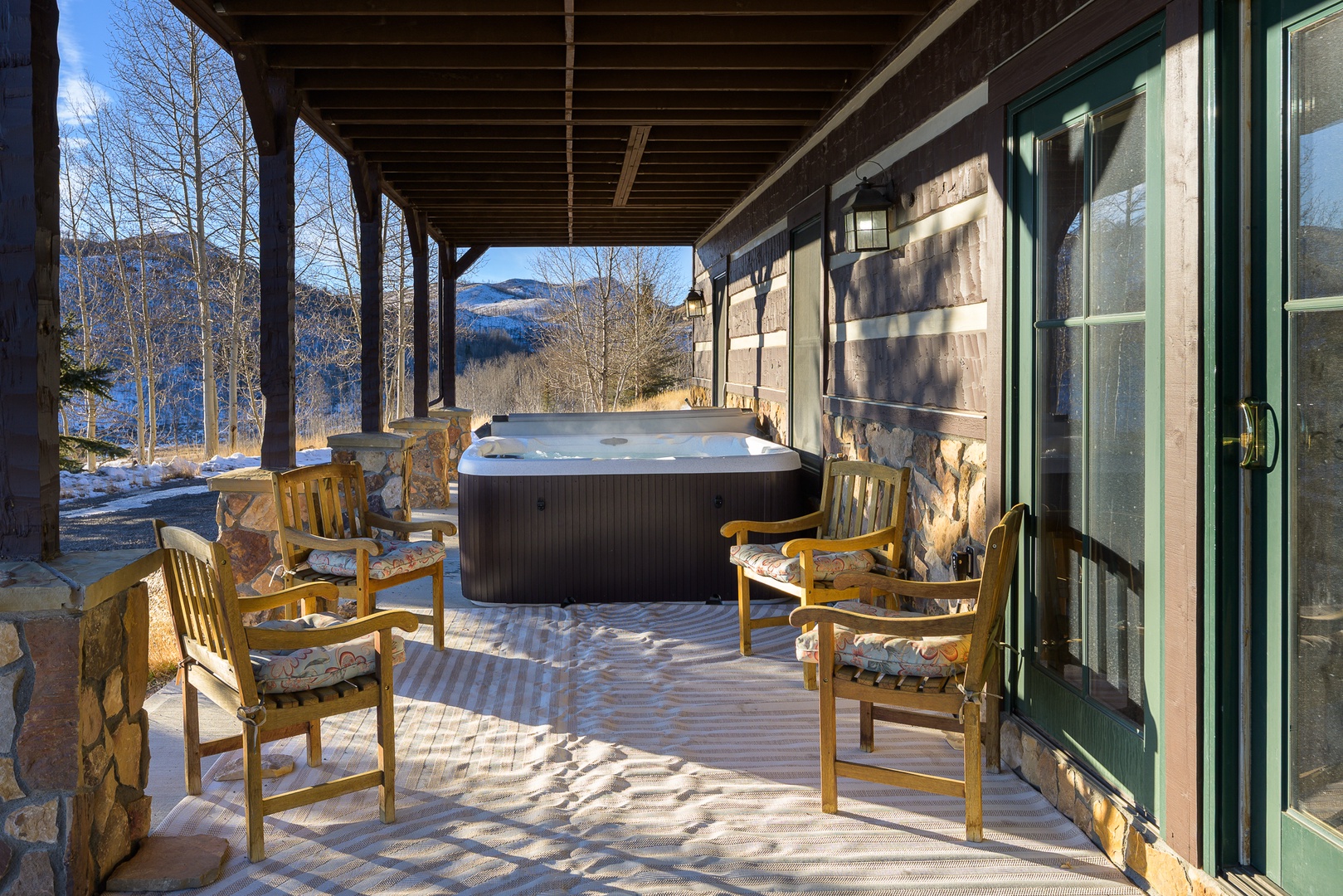 Soak in your private hot tub while mountain views stretch endlessly before you, creating the perfect winter retreat.