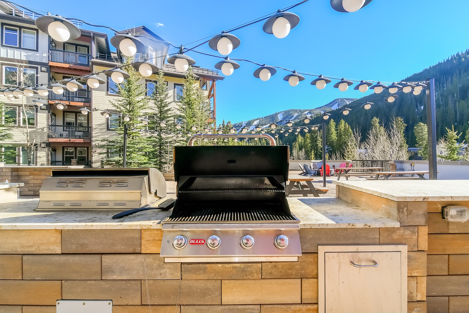 Fire up the built-in grill on the shared amenity rooftop terrace and savor mountain views just steps from the condo.