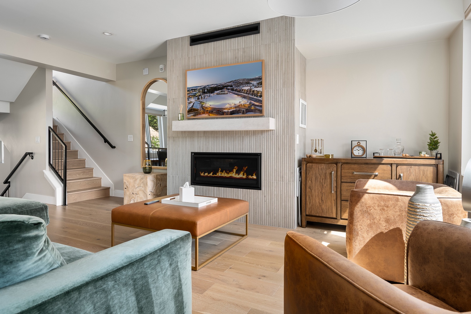 Relax in the cozy modern seating by the sleek gas fireplace.