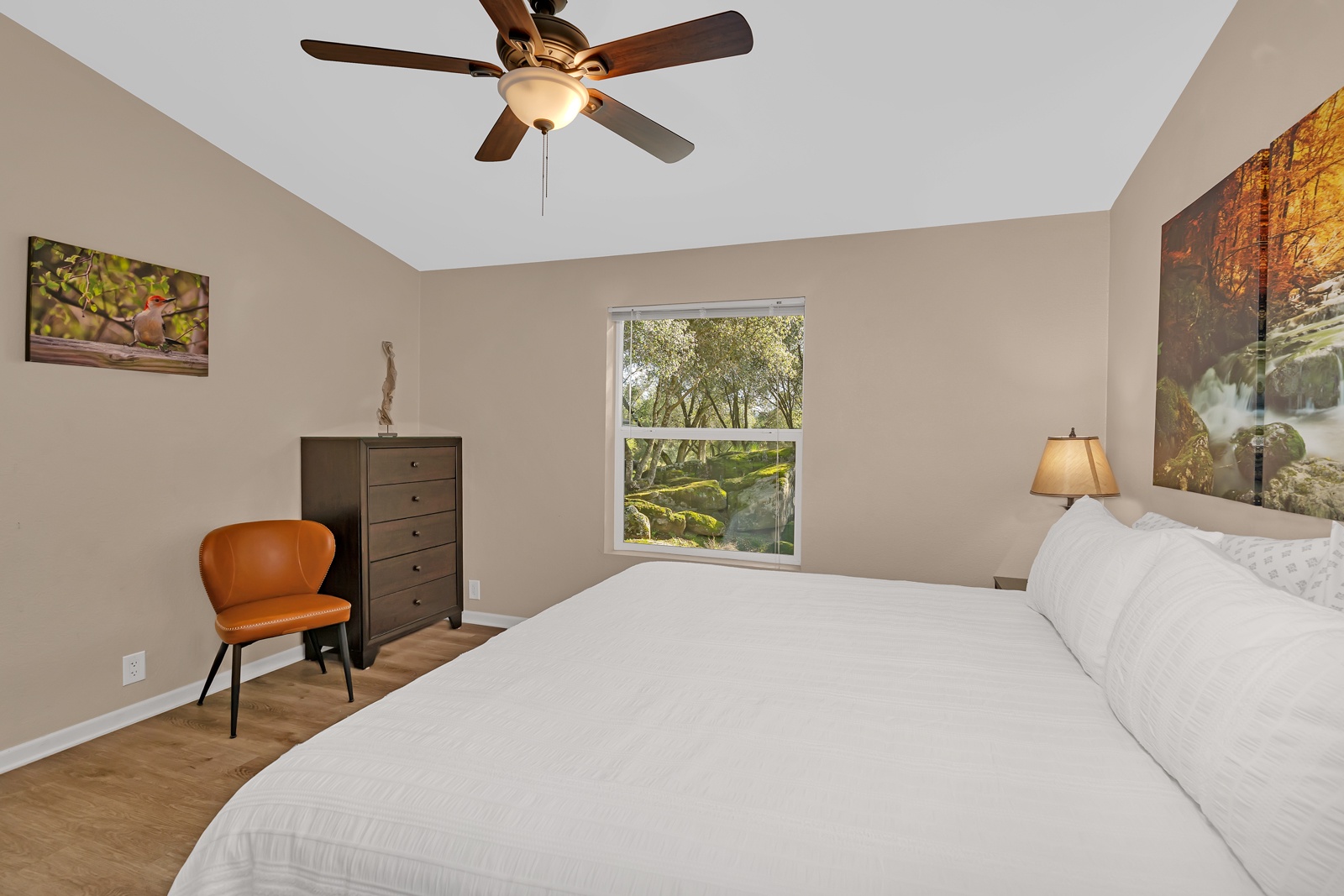 Enjoy a peaceful space with ceiling fan and lush views to start each morning refreshed.