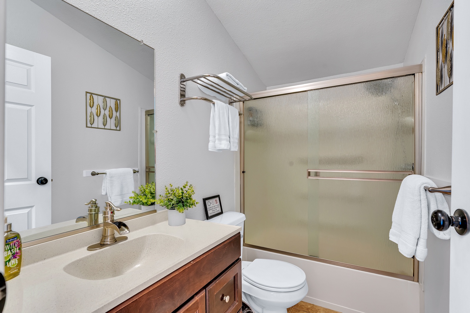Step into a bathroom with full tub with thoughtful touches that make getting ready a pleasure.