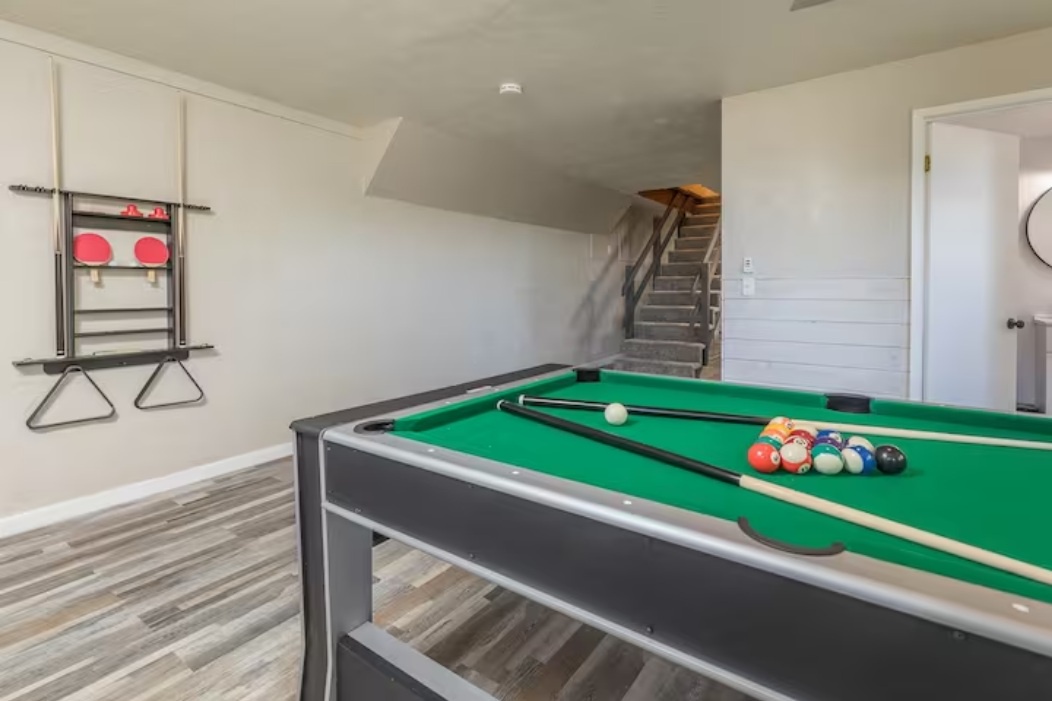 Challenge friends to a game of pool in your own private recreation room, complete with ping pong paddles ready for the next match.